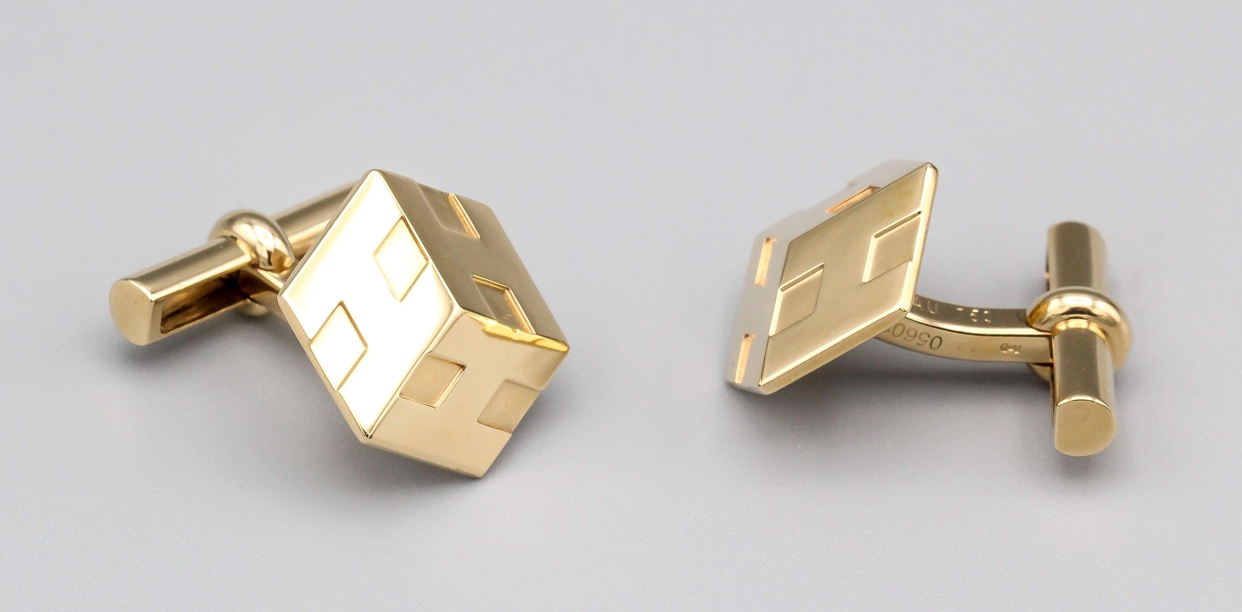 Fine pair of 18K yellow gold cufflinks by Hermes.  The resemble a 3d cube with the Hermes 