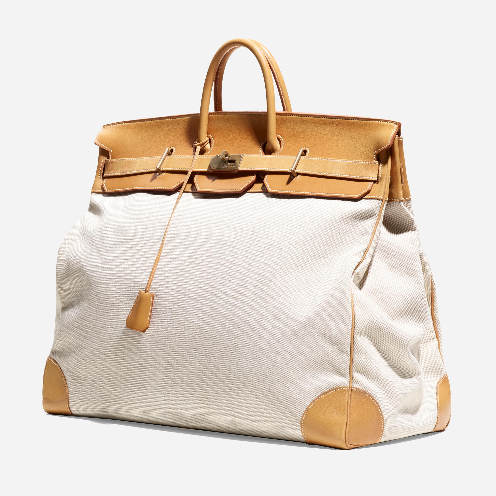 Made in: France, 1991

Material: leather, canvas, brass

Size: 21 h × 21 w × 11 d in

Description: Signed to exterior ‘Hermès Paris Made in France’ and clasp ‘Hermès Paris’.