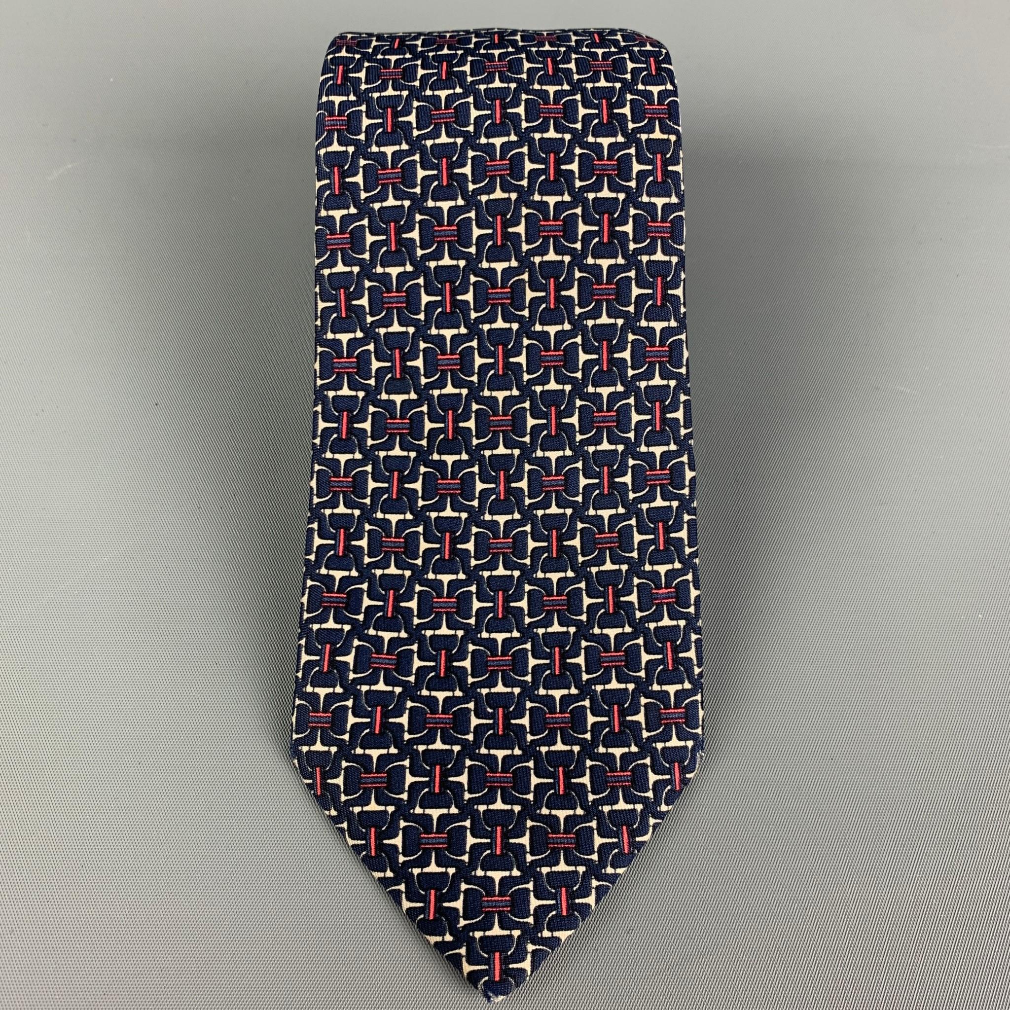 HERMES necktie comes in a navy & white silk with a all over equestrian print. Made in France.

Very Good Pre-Owned Condition.
Marked: 7058 TA

Width: 3 in. 