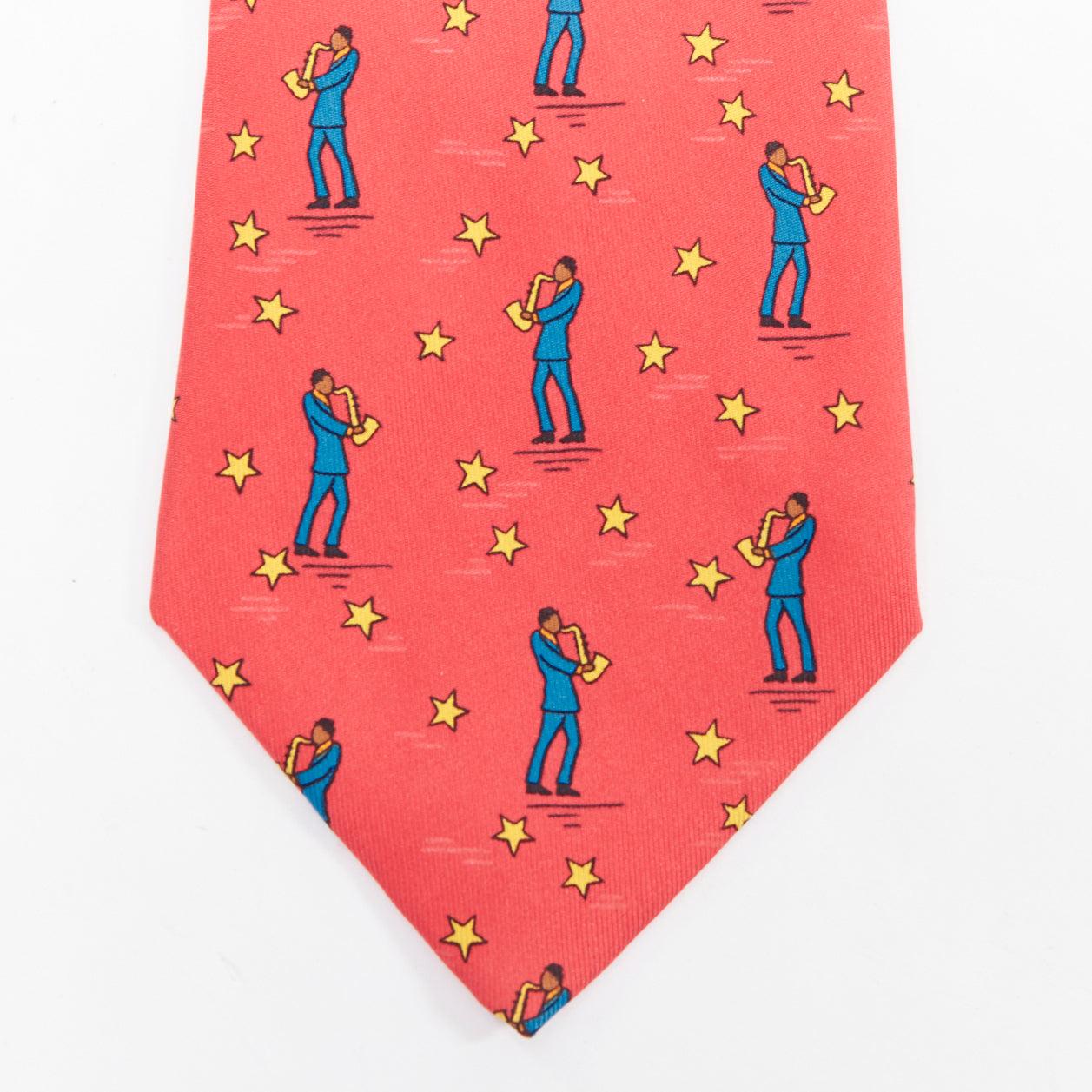 HERMES 7551 SA red yellow blue saxophone player star print silk tie
Reference: TGAS/E00700
Brand: Hermes
Model: 7551 SA
Material: Silk
Color: Red, Blue
Pattern: Cartoon
Lining: Red Silk
Extra Details: Saxophone man with stars print.
Made in:
