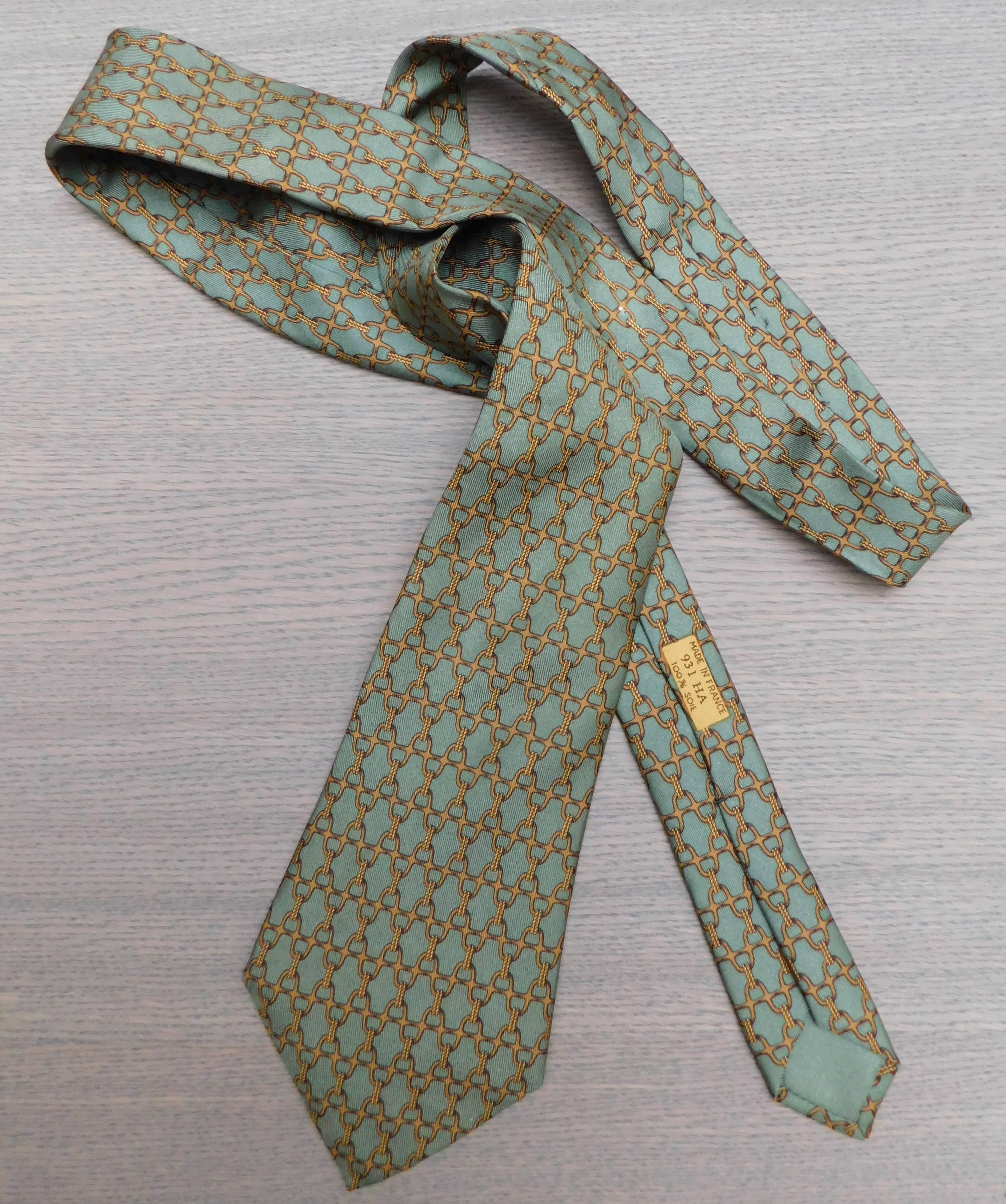 Hermes vintage silk tie in one of the most desirable Hermes equestrian patterns. The elegant combination of olive green and gold is perfect for every season and occasion.
the width at the widest point is 9cm.