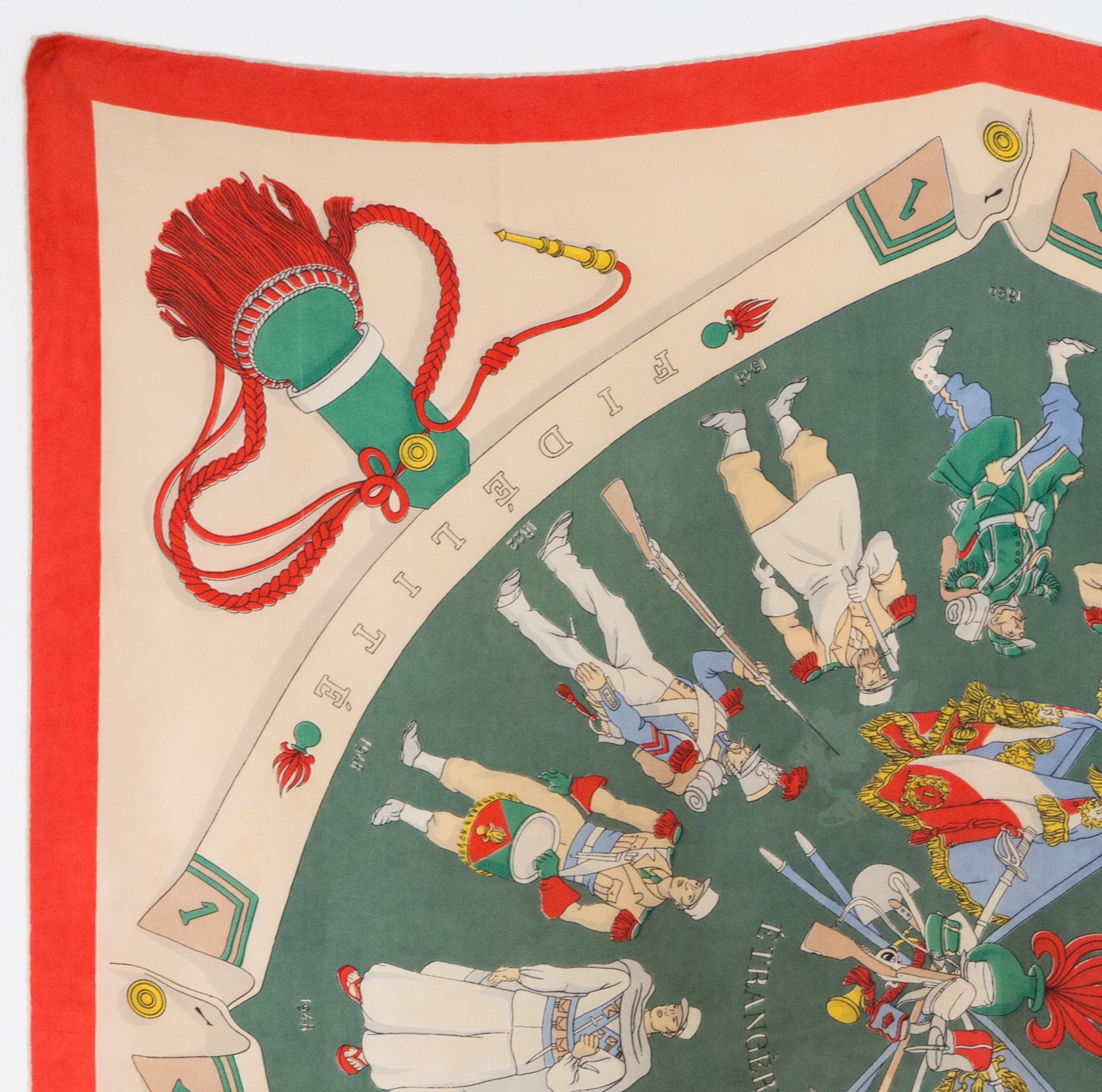 Hermes silk scarf A la Gloire de la Legion Etrangere designed by Hugo Grygkar in 1951 (reissued in 1963), featuring ared and green border. 
In good vintage condition. Made in France.
35,4in. (90cm)  X 35,4in. (90cm)
We guarantee you will receive