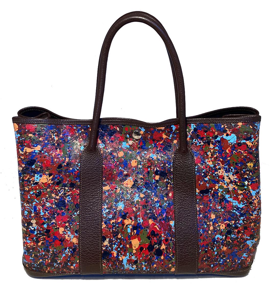 Hermes Hand Painted Garden Party 35 Tote in good condition. Navy canvas hand painted exterior with brown leather trim and silver hardware. Unique, hand painted pointillism style exterior in multicolor print. Top snap closure opens to a navy canvas