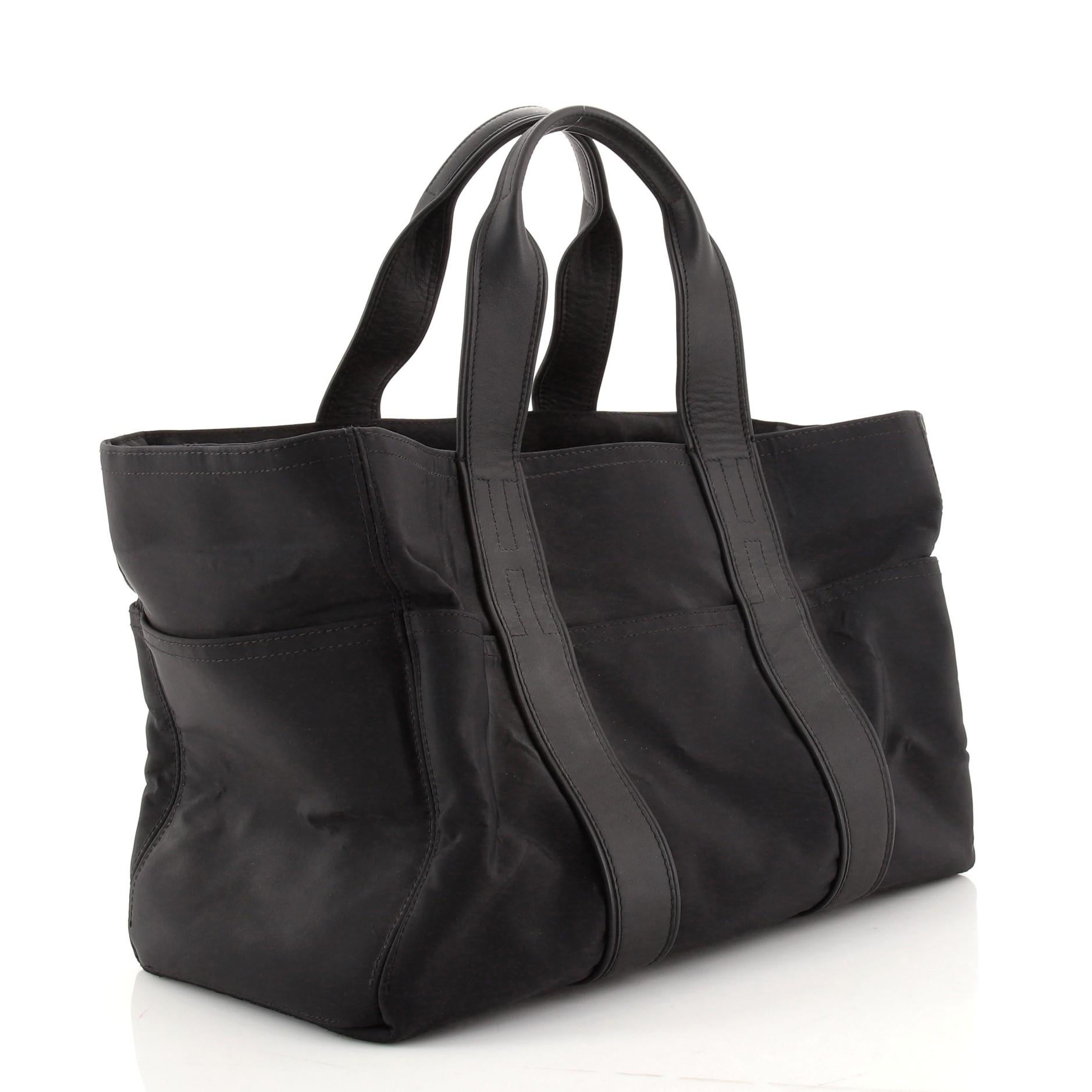 Condition: Very good. Odor in interior. Loss of shape, bubbling and wear on exterior and in interior, light scuffs and small indentations on leather trims, creasing on handles. Peeling on zipper pull wax edges, scratches on hardware.
Accessories: No