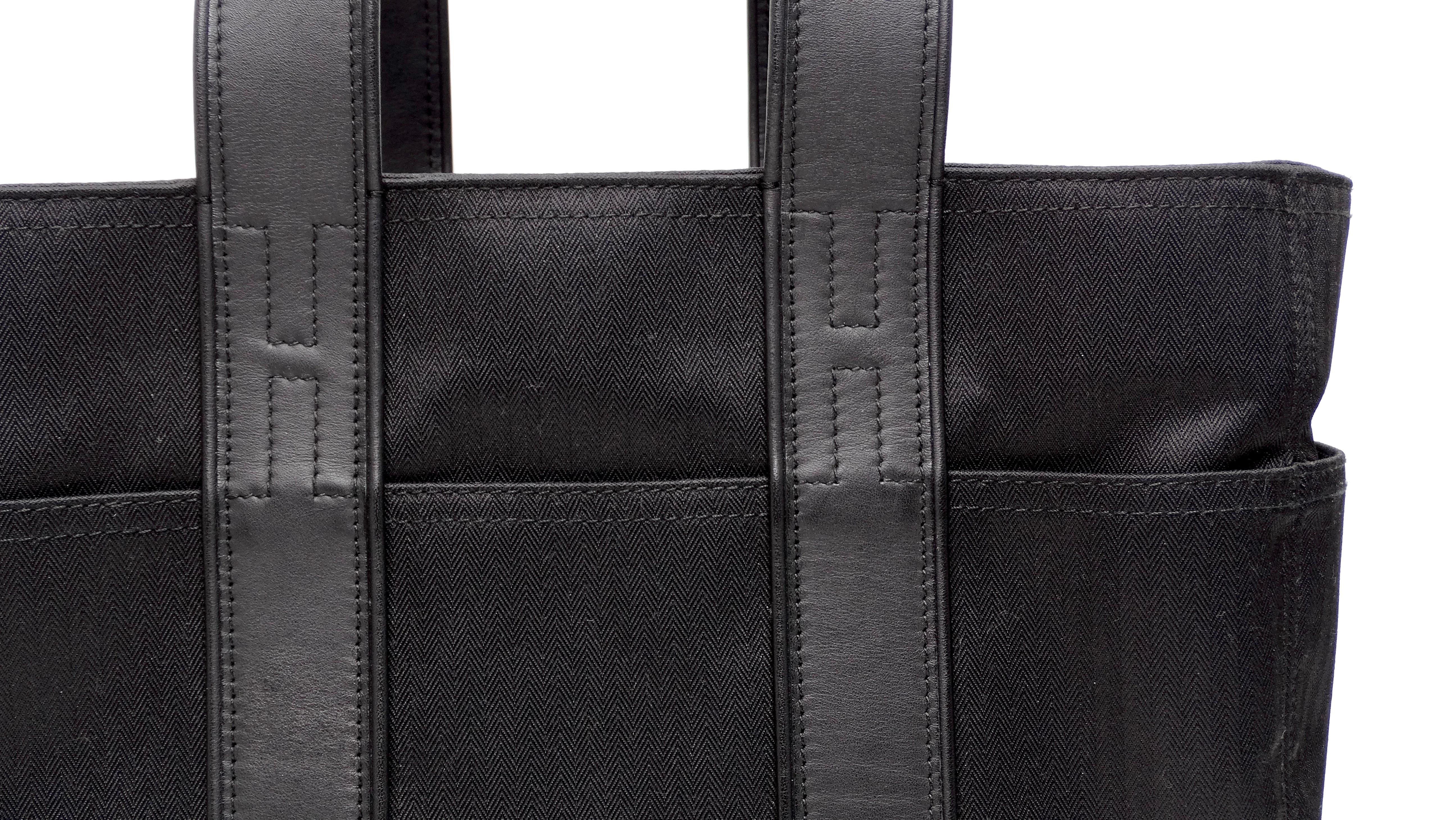A Hermes vintage sporty gem! This is an authentic black Acapulco toile and leather tote from none other than Hermes! This sporty tote bag can be used in so many versatile ways. Use it for anywhere from your day-to-day bag when you need a bag with a