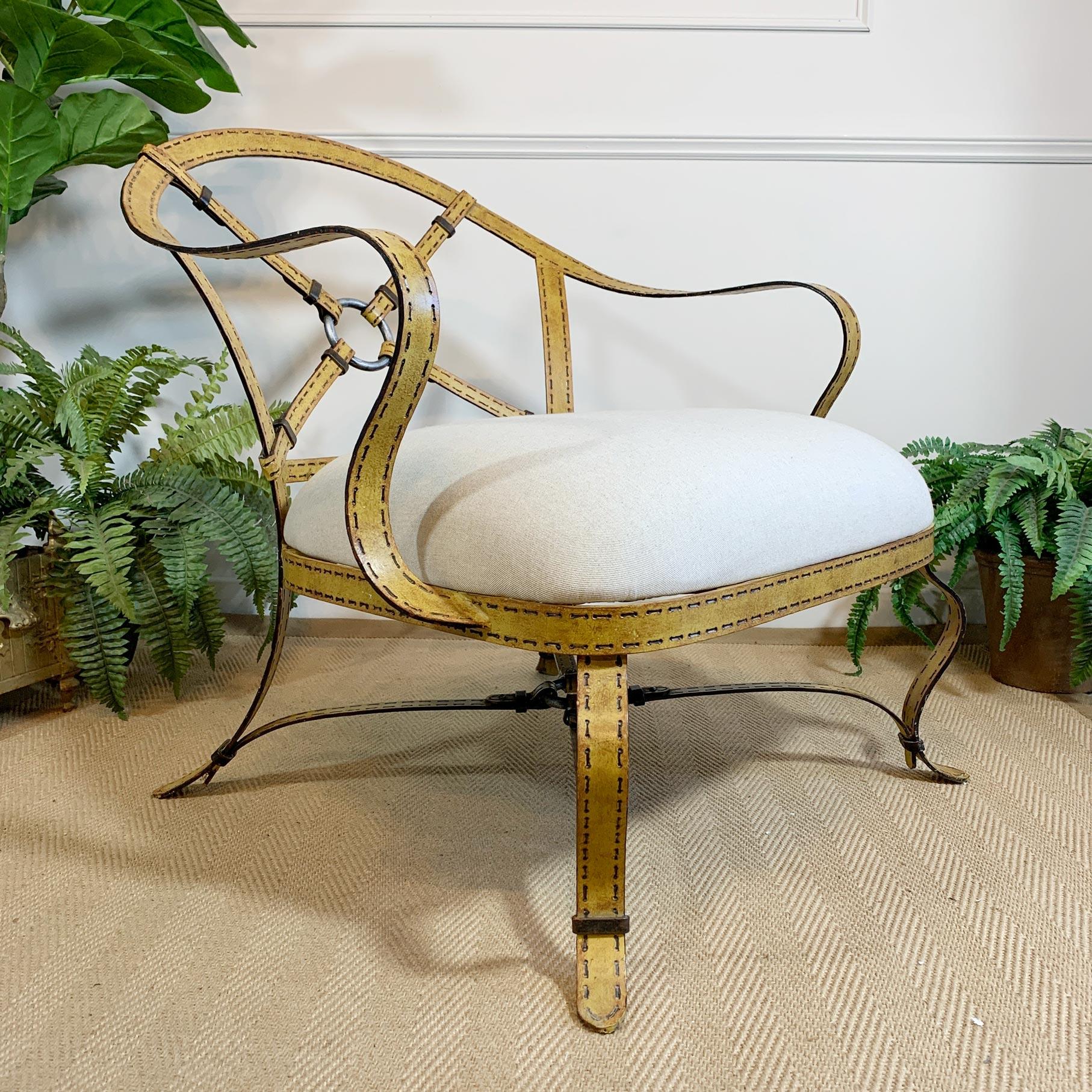 Incredible wrought iron chair, the frame designed to replicate leather equestrian harness straps, very much in the manner of Hermés and Jacques Adnet. 

The attention to detail is quite exceptional, the trompe l’oeil technique has been used to