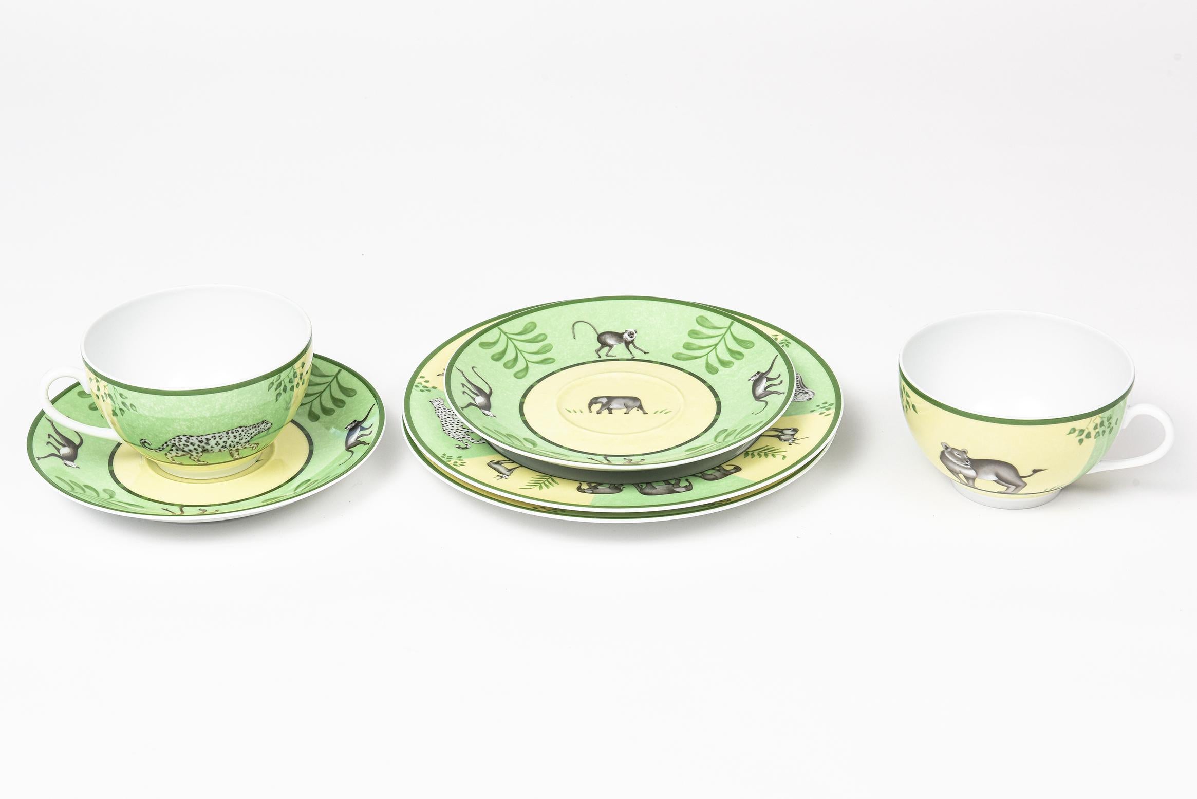 Africa Green Breakfast set by Hermes is green and yellow with a green border and jungle animals. Made in France CIRCA: 1997-2014. The set includes a pair of breakfast cups (Lion & Lioness) and saucers (Elephant center and leaf & monkey border). Also