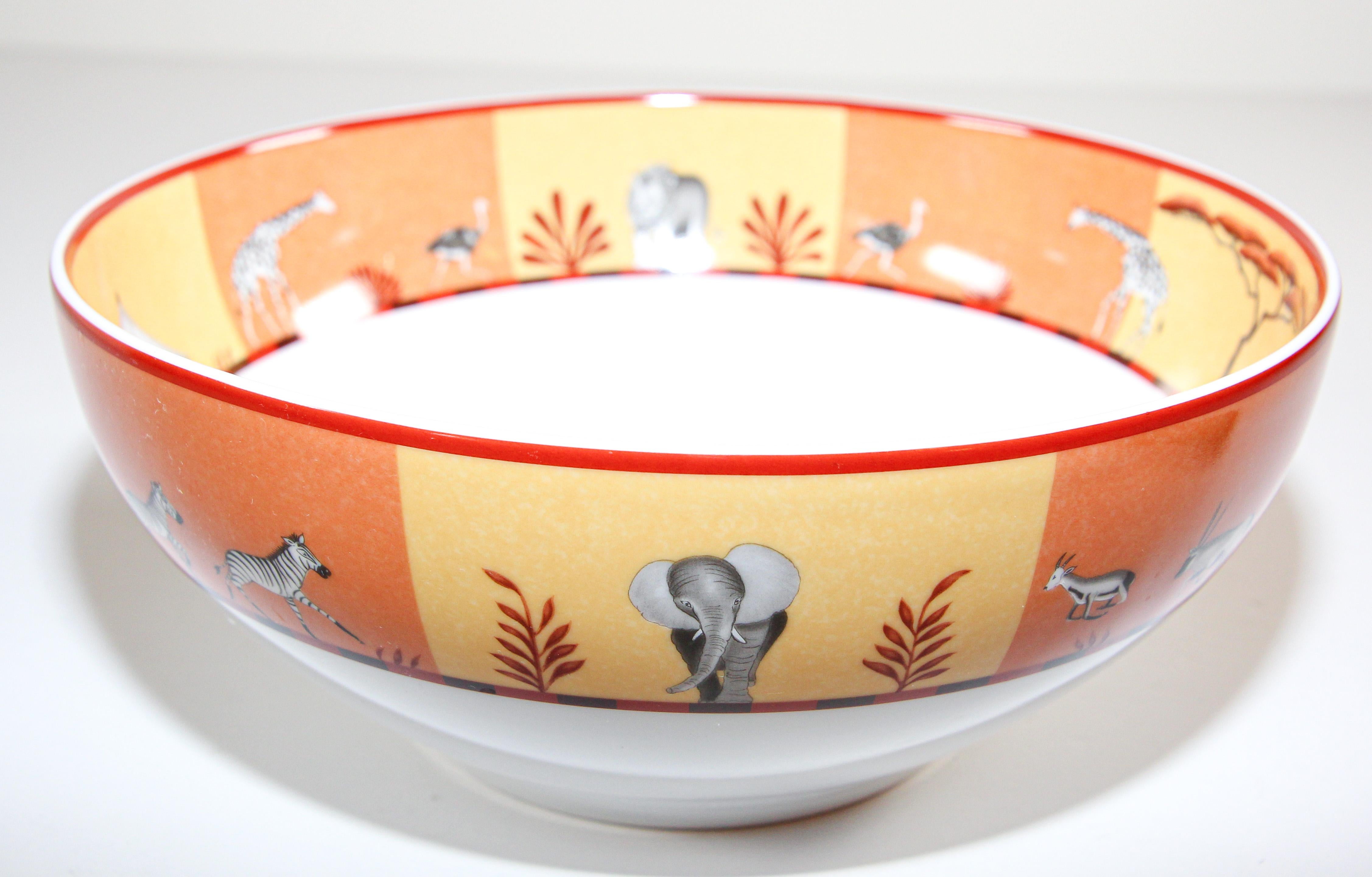 Hermès porcelain Africa orange large salad bowl or pasta bowl with Safari animals design.
in the Africa pattern by Hermes, this lovely rimmed salad, pasta or fruit bowl features white fine bone china decorated with a wide orange and yellow border