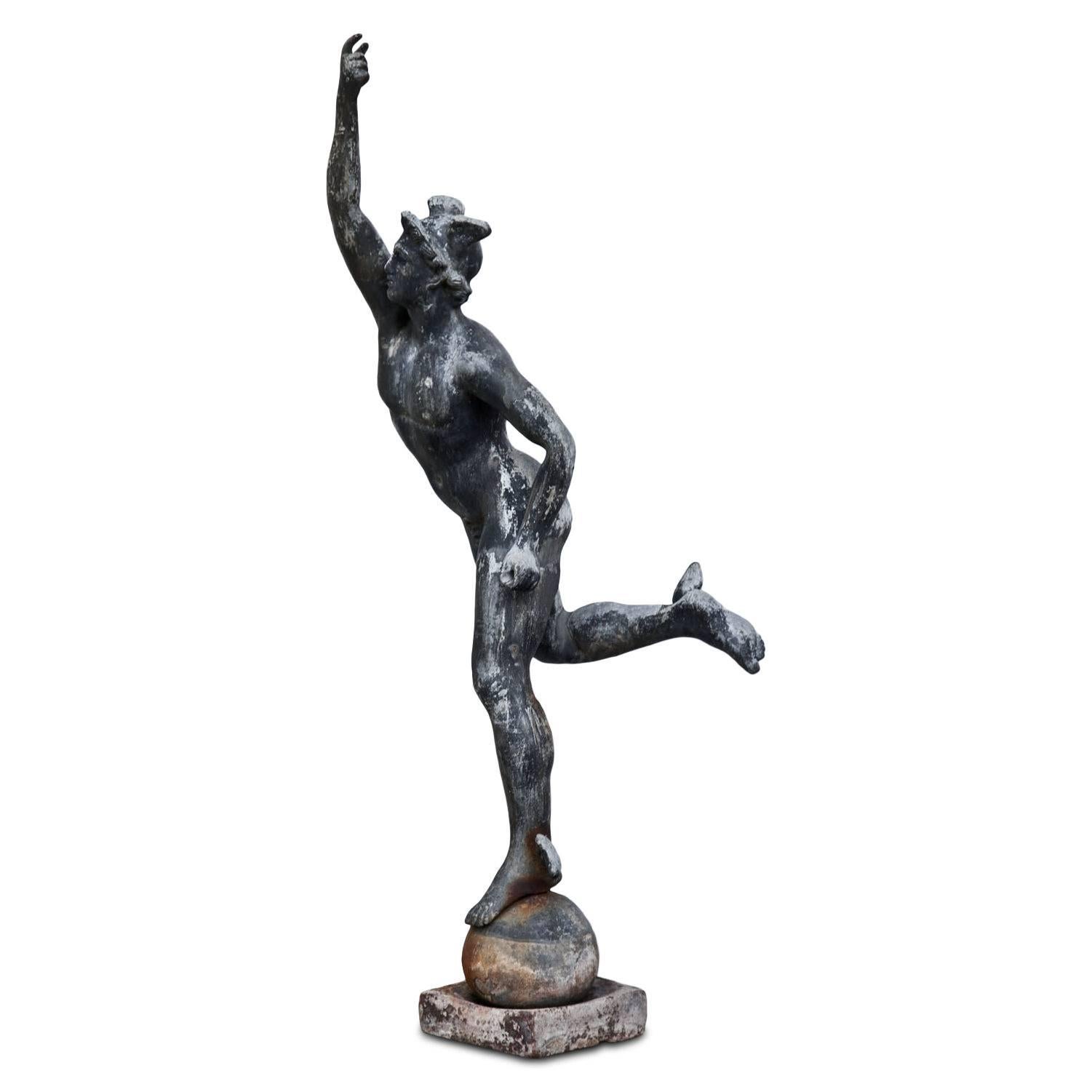 Large lead figure of the famous Hermes after Giambologna, of the 19th century. Hermes stands on a sphere with a square base and reaches out with his right hand. The lead figure has a beautiful natural patina; the Rod of Asclepius is missing.