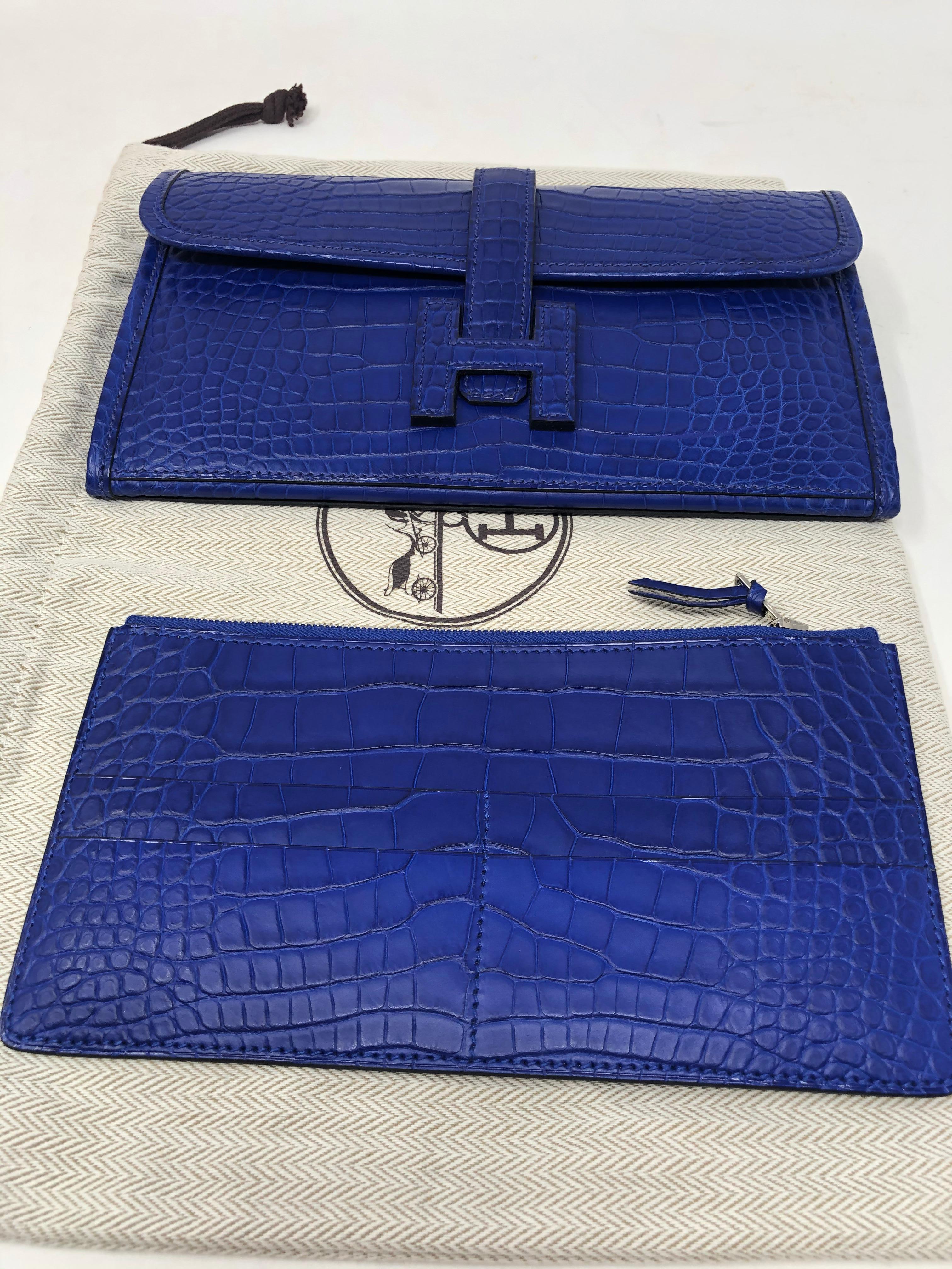 Hermes Crocodile Bleu Electrique Jige Duo Wallet. Hermes long wallet in matte Alligator. Can be worn as an evening or day clutch. Includes insert for holding cards, etc. Never used. Stayed in the box. Purchased at Hermes $20,200. Includes dust cover