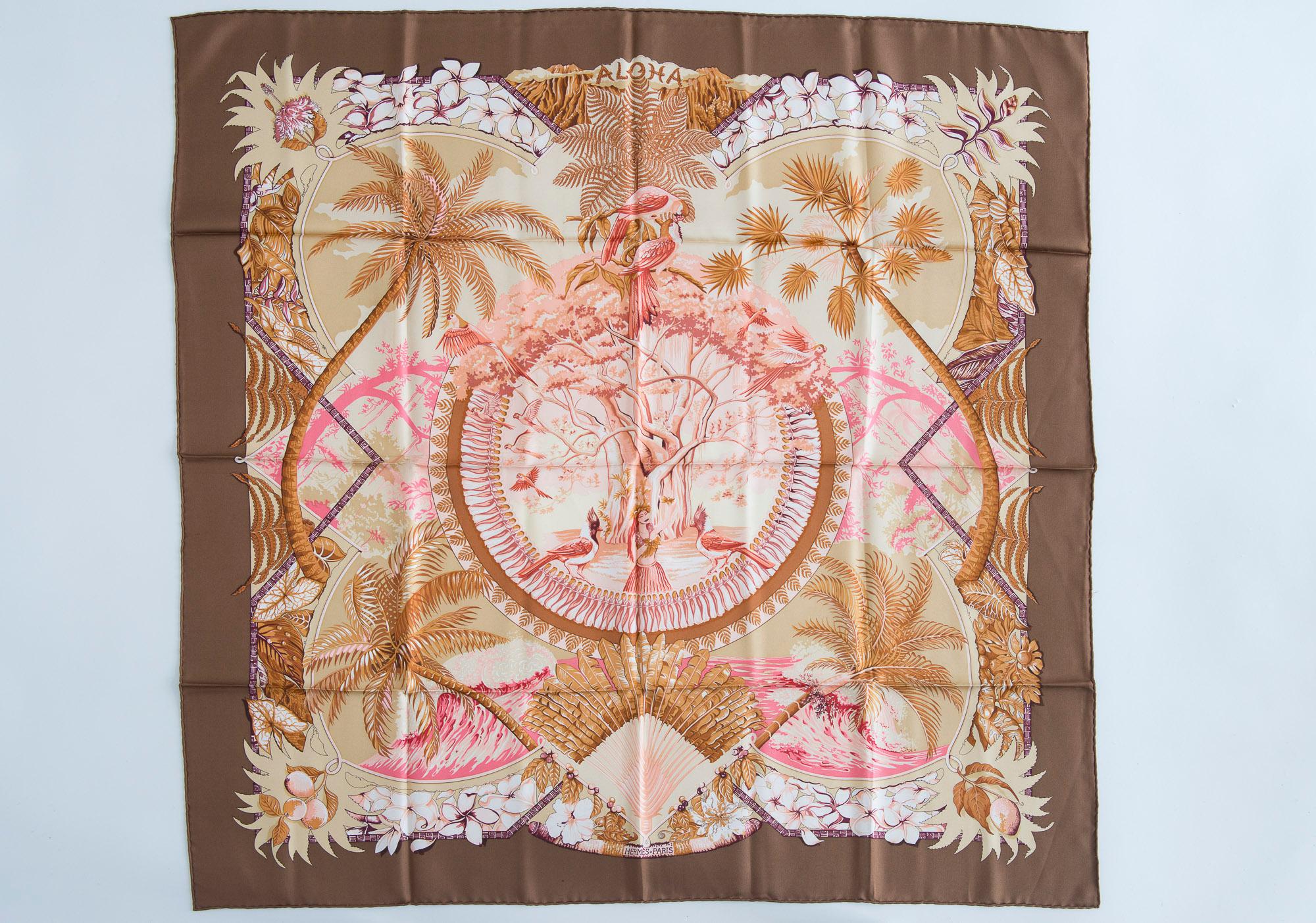 Authentic Hermès Aloha 90 cm silk scarf in a rare colorway. Originally designed by Bourthomieux in 2000, the print features a taupe border with beautiful shades of pink at the center design. Tropical theme with palm trees, exotic birds and hula