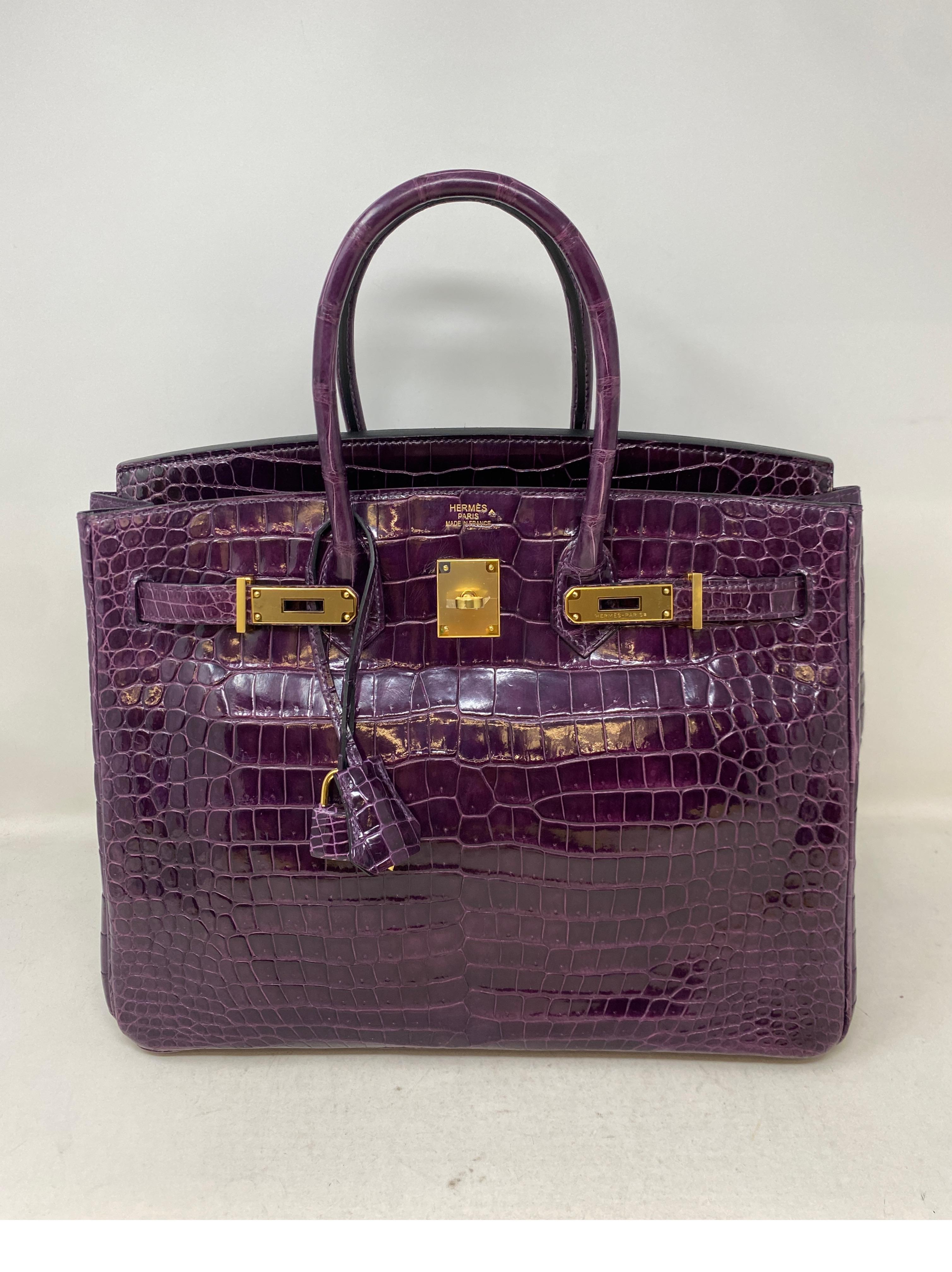 Hermes Amethyst Crocodile Birkin 35 Bag. Exotic rare shiny crocodile bag with gold hardware. Excellent condition. Looks unworn. Plastic still on hardware. Own one of the rare exotics out there. The color is stunning. Includes full set. Clochette,