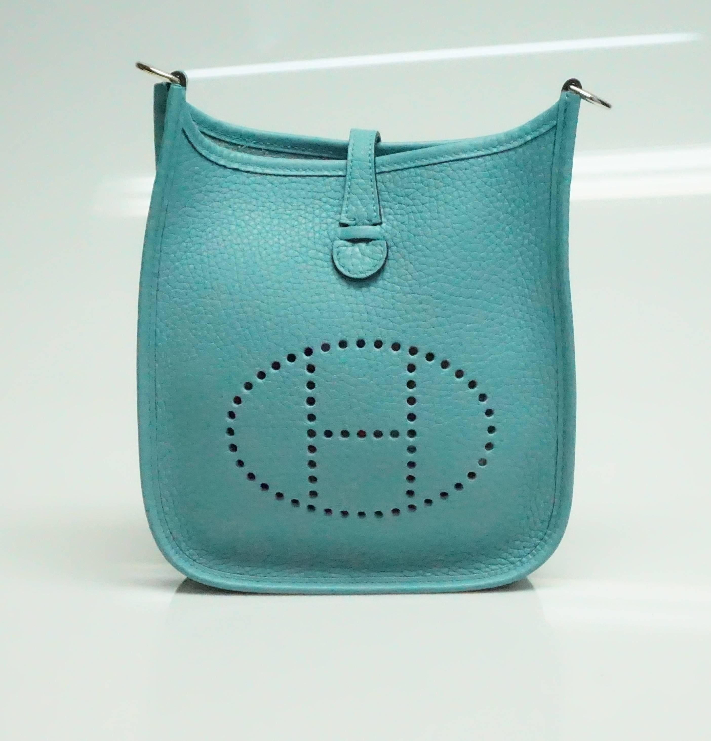 This beautiful Hermes TPM Mini Evelyne crossbody is made of Clemence leather in the color Aqua. This bag  is new/never carried and comes with the duster and box. 

Measurements
Length: 7