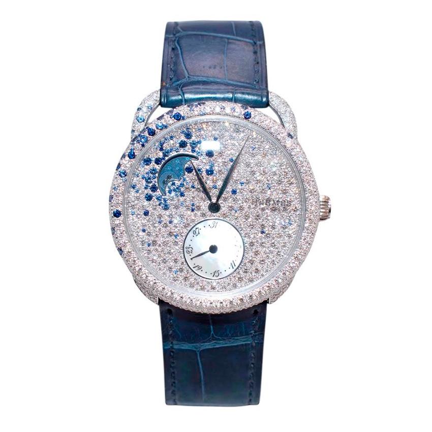 Hermés Arceau Petite Lune Watch with Sapphires & Diamonds

-White Gold Gem Set Face 
- 1025 diamonds (5.99ct), 133 blue sapphires (1.05ct) and 1 0.07ct rose cut diamond)
-Mechanical self-winding movement
- Made in Switzerland
- 38mm case
- Crystal