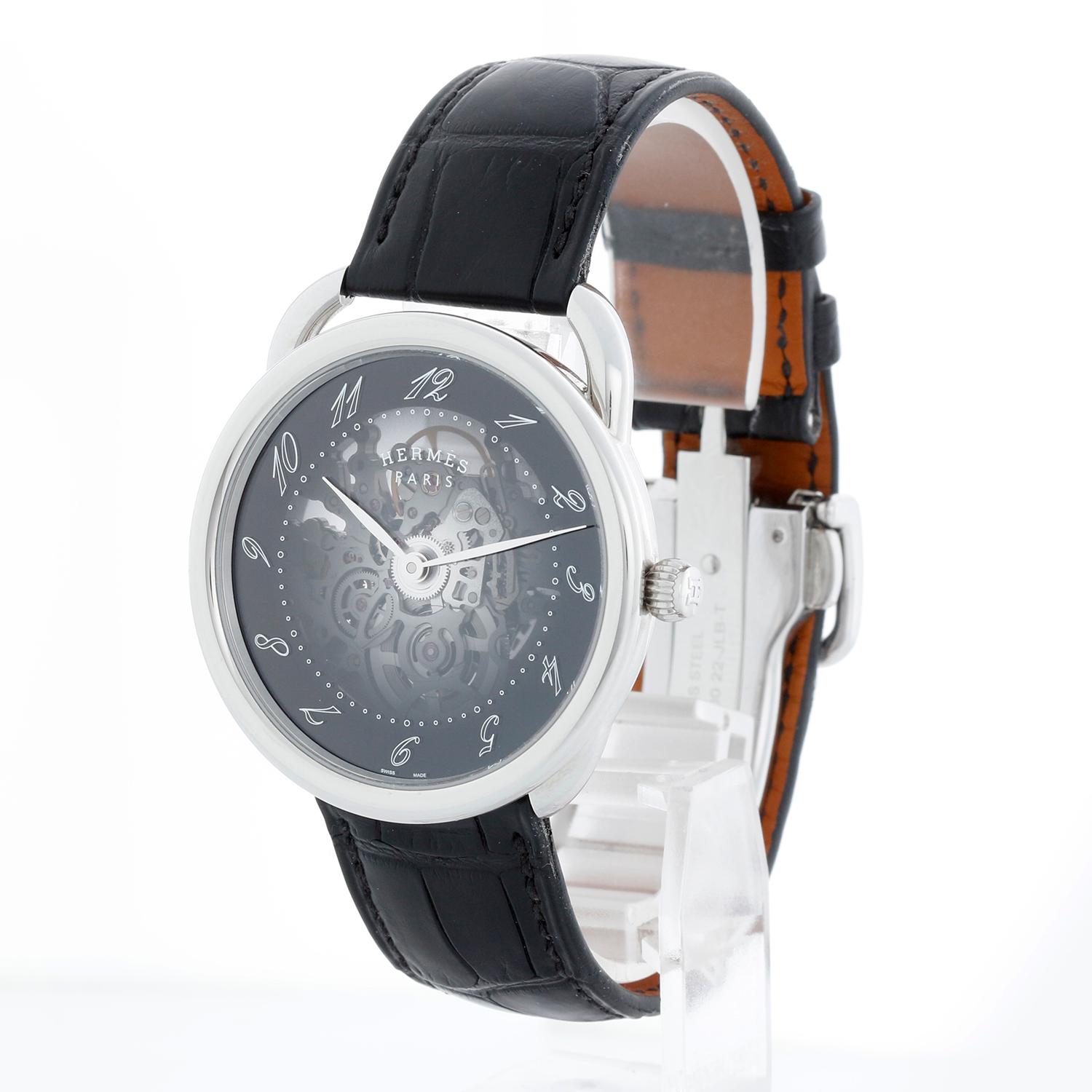 Hermes Arceau Skerret Automatic 40mm Mens Watch  AR2.710 - Automatic. Stainless steel with smooth bezel with a exposition caseback (40 mm). Skeleton dial with black outer ring. Matte black alligator leather strap with a deployant clasp.. Pre-owned