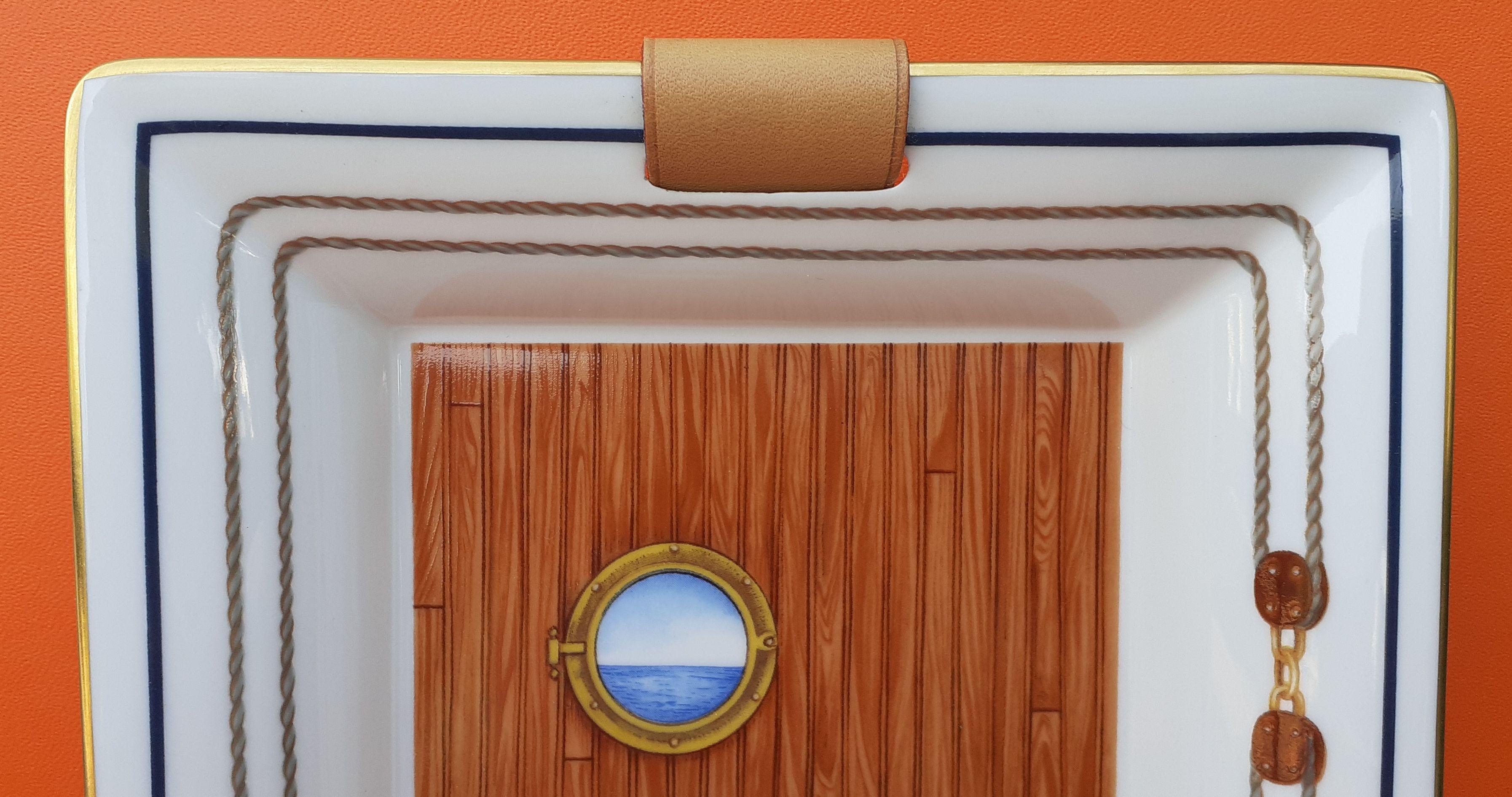 Beautiful Authentic Hermès Change Tray

Pattern: porthole, lifebuoy and pulleys

Made in France 

Probably Vintage

Made of printed Porcelain and Leather

Colorways: White, Light Brown, Blue

The drawing is covered with varnish, which gives it a