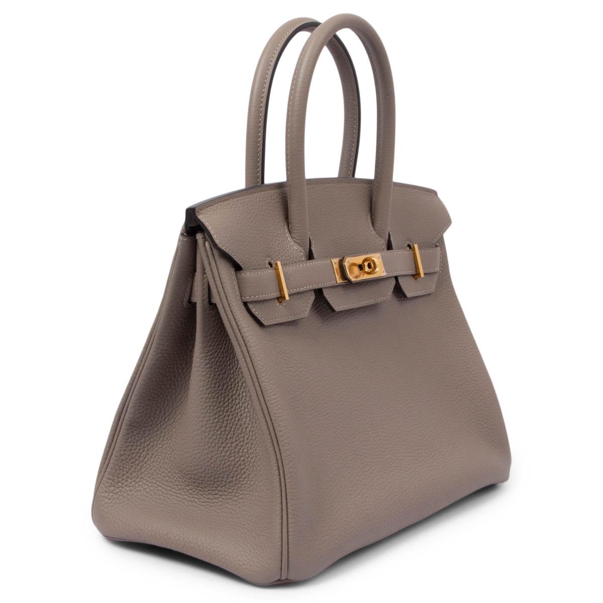 100% authentic Hermès Birkin 30 bag in Asphalt (grey) Togo leather with gold-plated hardware. Lined in Chevre (goat skin) with an open pocket against the front and a zipper pocket against the back. Has been carried and is in excellent condition.