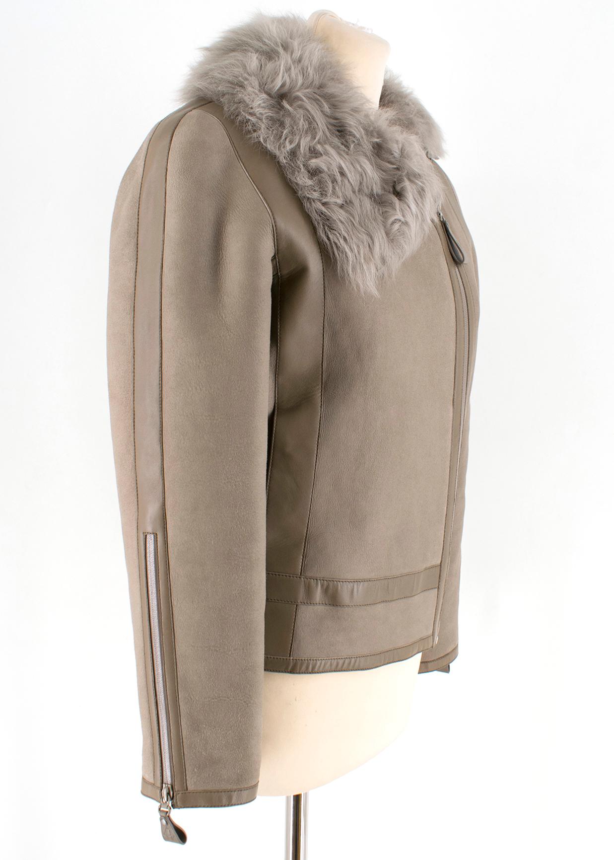 Hermes Asymmetric Suede & Shearling Jacket With Lambs Fur Collar 

Grey Lambskin Suede outer
Lamb shearling lining with a lambs fur collar
Asymmetric Zipper closure
Two interior pockets 
Two slip pockets
Two buckle features on lower back