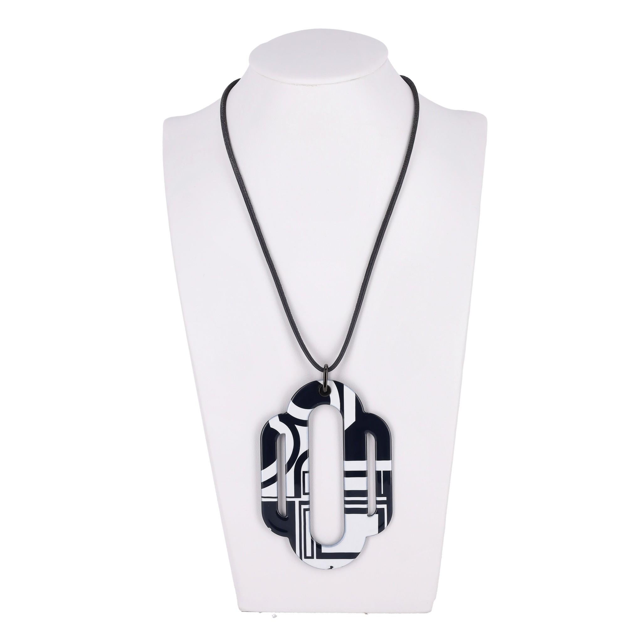 Hermes Attelage Les Coupes Tattoo Pendant Necklace

Black and white oversized pendant in printed enamel on black Swift leather cord detailed with 'Hermes Made in France' black buckle.

Size – One Size

Condition – Good (Chipped edges)

Composition –