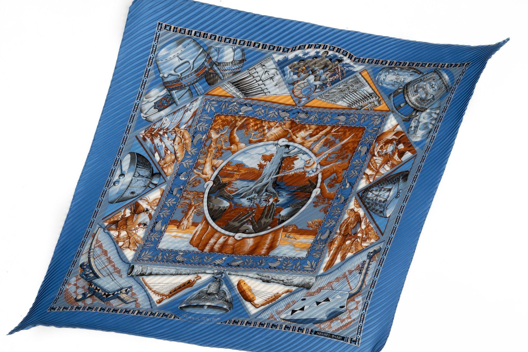 Hermès “Au son du tam tam” plisse’ blue silk scarf. No label, comes with original box.