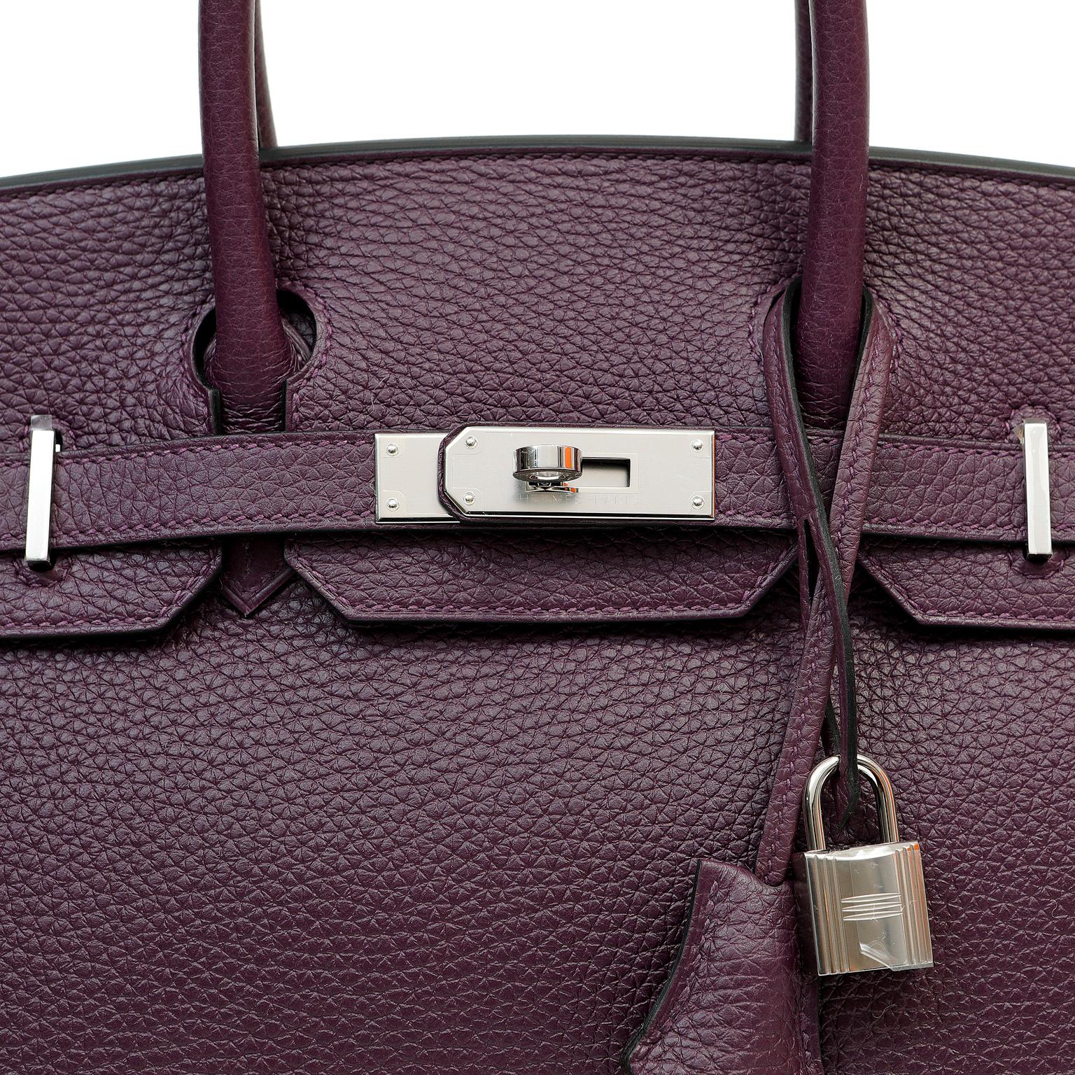 This authentic Hermès Aubergine Togo Leather 30 cm Birkin Bag is in pristine unworn condition.  A brand new deep purple color from 2022, this piece has the plastic on all the hardware and is exquisite.

Togo is scratch resistant calf leather; it is