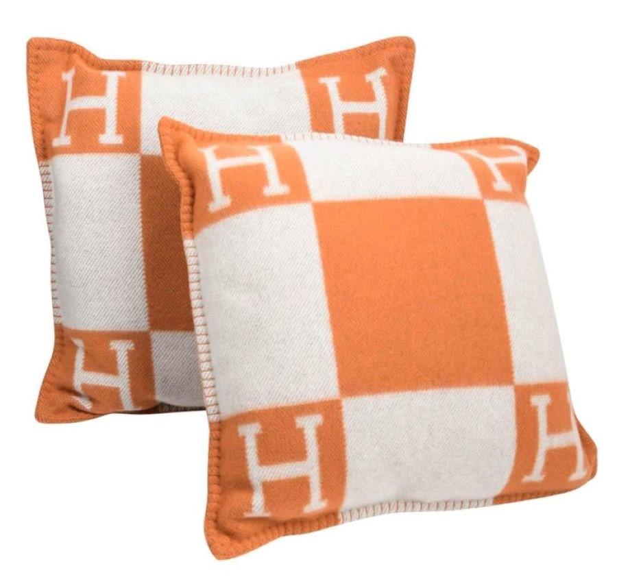 Hermes Avalon Blanket Wool Cashmere Orange Cream w/Matching Pillows. Wonderful Hermes colors. the orange is a staple in the Hermes look and this throw and pillows set are a wonderful pairing.

Pillows measure - 20 x 20
Thrown Measures - 54 x 66.