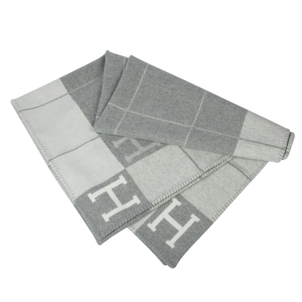 Mightychic offers a guaranteed authentic Hermes classic Avalon III signature H blanket features Gris Clair and Ecru.
Created from 90% Merino Wool and 10% cashmere and has whip stitch edges.
New or Pristine Store Fresh Condition. 
Please see the