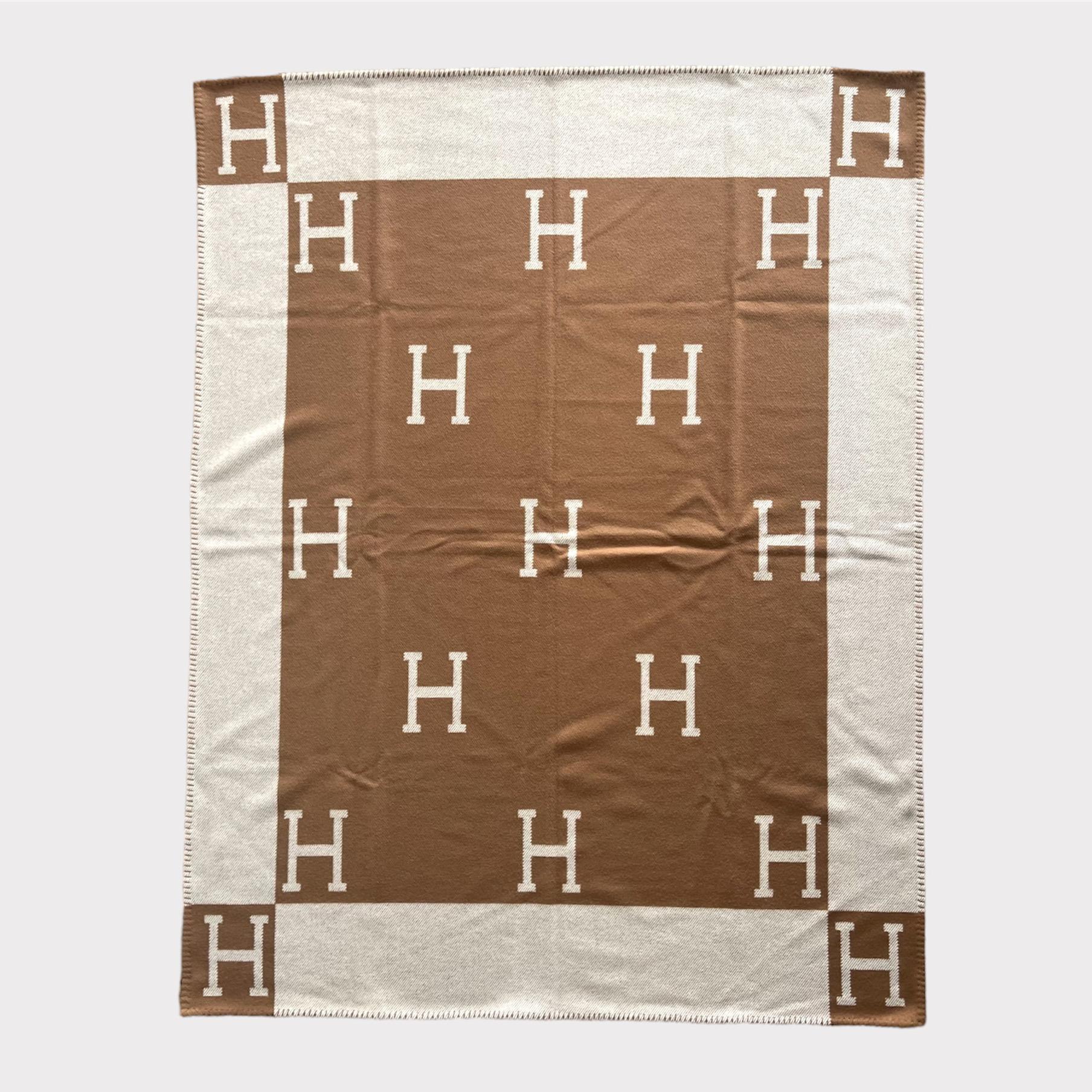 The Hermès Avalon Throw blanket is the iconic and highly sort after piece from the Hermes homeware collection. This blanket is made from 90% Merino Wool and 10% Cashmere making it warm and soft, perfect for a summer evening outside or a winter