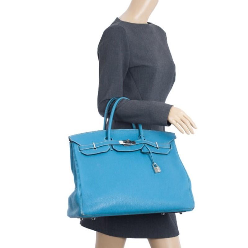 This gorgeous Birkin features an azure blue color. Crafted from buffalo calfskin leather, this bag is definitely a masterpiece! The leather is brought to life with silver-tone hardware, including the signature flap opening secured with a turn lock