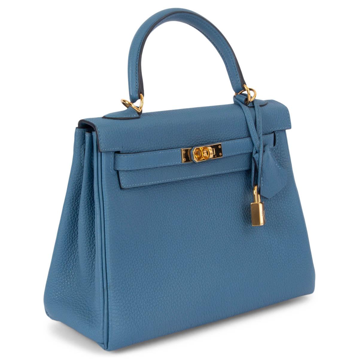 100% authentic Hermès Kelly II 25 Retourne bag in Azur blue Veau Togo leather with gold-plated hardware. Lined in Chevre (goat skin) with an open pocket against the front and a zipper pocket against the back. Has been carried and is in virtually new