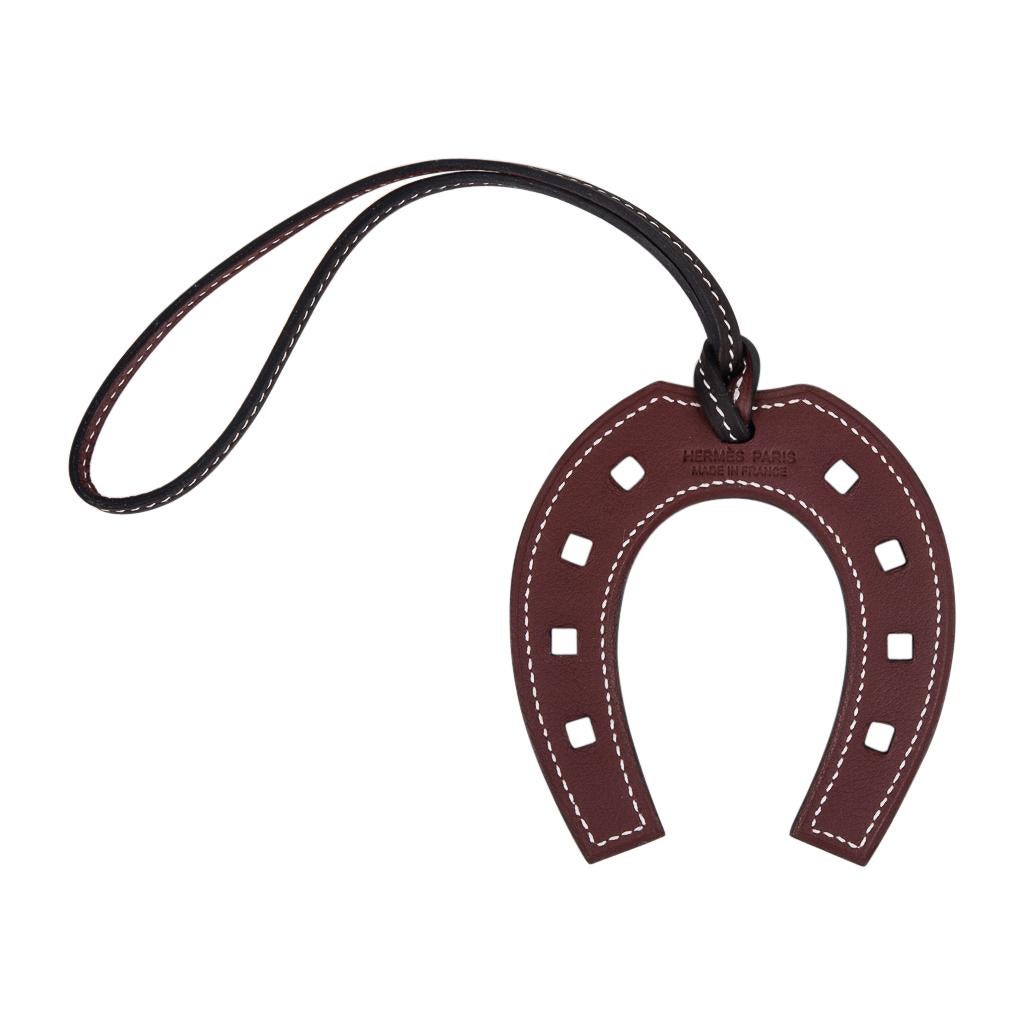 Guaranteed authentic Hermes Paddock Fer a Cheval Horse Shoe bag charm.
This equestrian bi-color charm is featured in Black and Rouge and will add a delightful touch to a myriad of your bags!
Stamped Hermes Paris Made in France.  
Comes with
