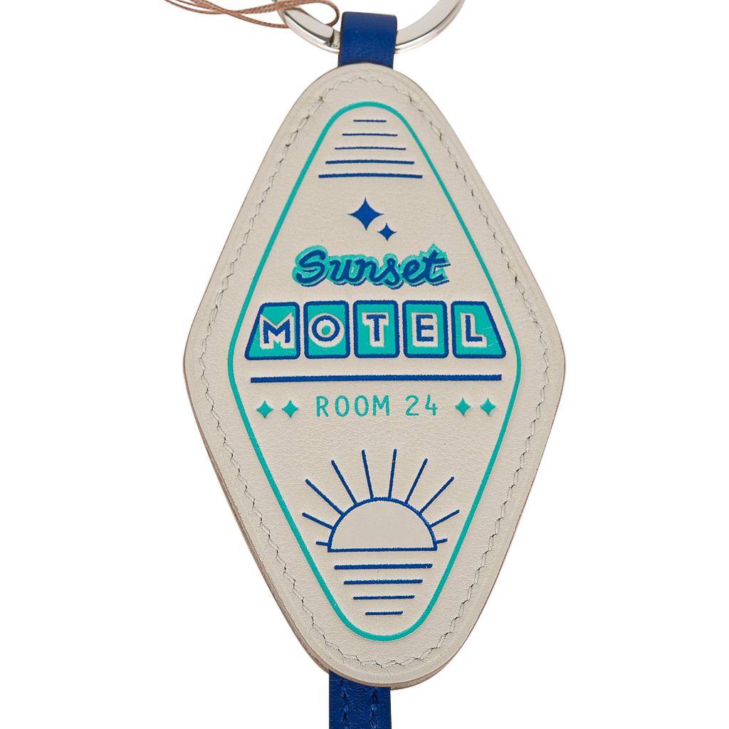 Guaranteed authentic rare limited edition Hermes Sunset Motel Room 24 Key Ring featured in Gris Perle with Blue swift leather.
Charming with a play on a retro hotel room key embossed in blue and green. 
Key ring on each end.
Comes with signature