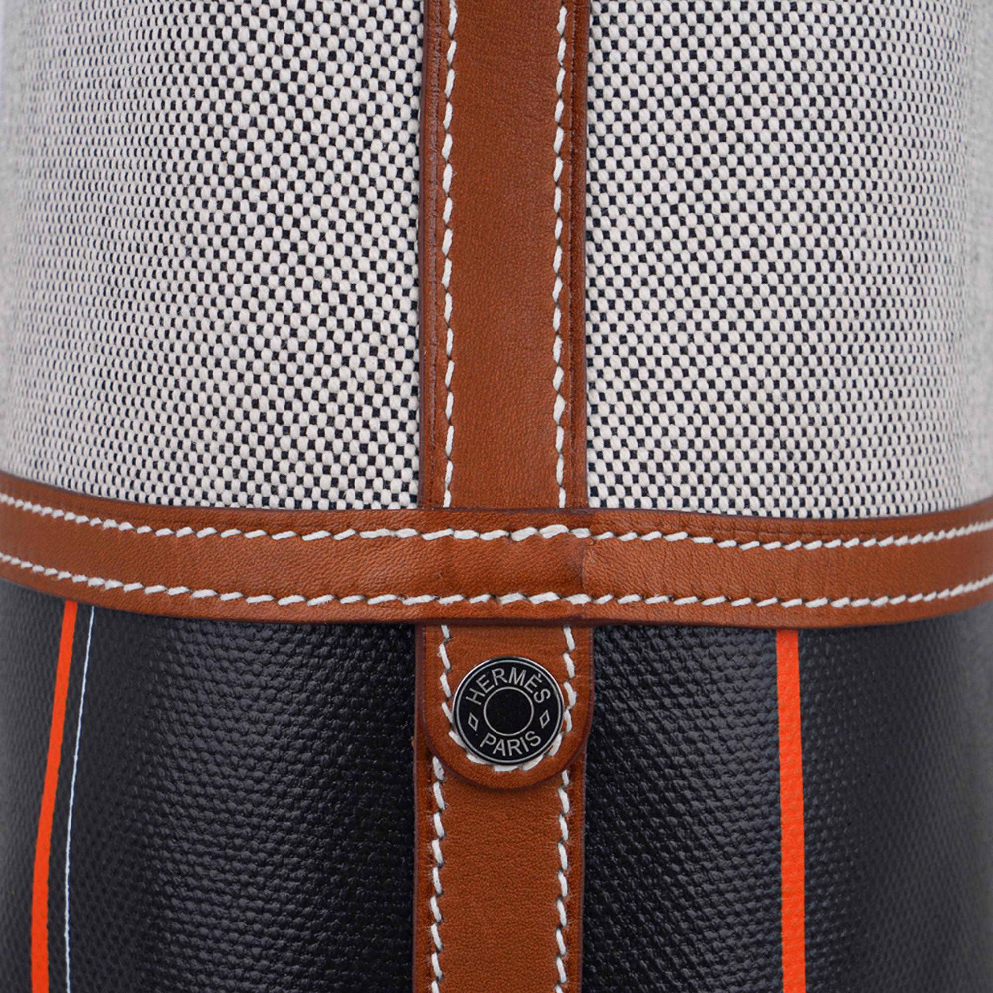 Mightychic offers a guaranteed authentic Hermes Col Roule is featured in Noir Toile Berline,
Orange Window Pane and Toile.
Barenia single handle with Palladium bridle rings and signature white topstitch.
Accented with palladium Clous de