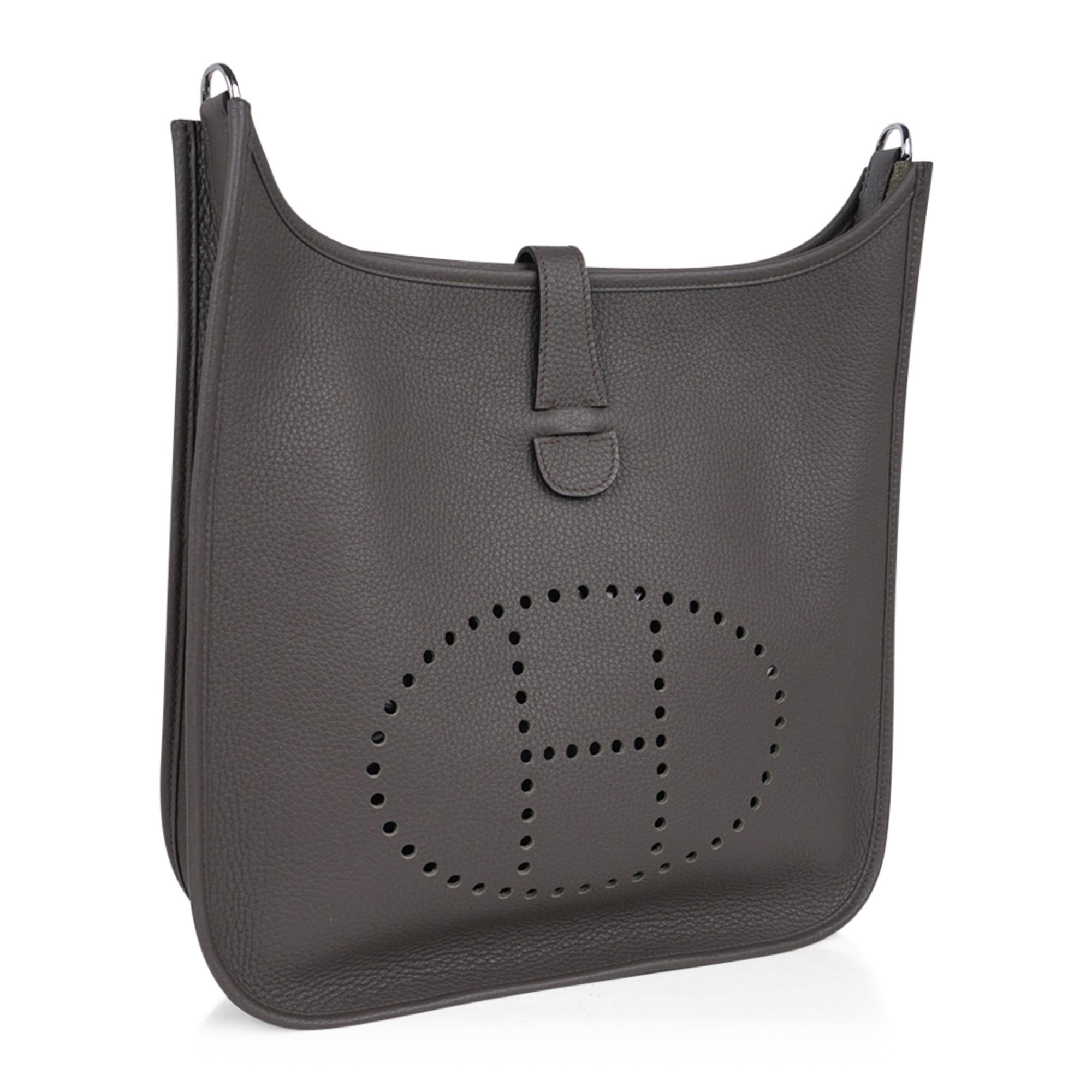 Guaranteed authentic Hermes Evelyne GM featured in Etain clemence leather.  
Fabulous shoulder or cross body bag with roomy interior and rear outside deep pocket. 
Sport strap in textile with leather and palladium hardware details.
Signature