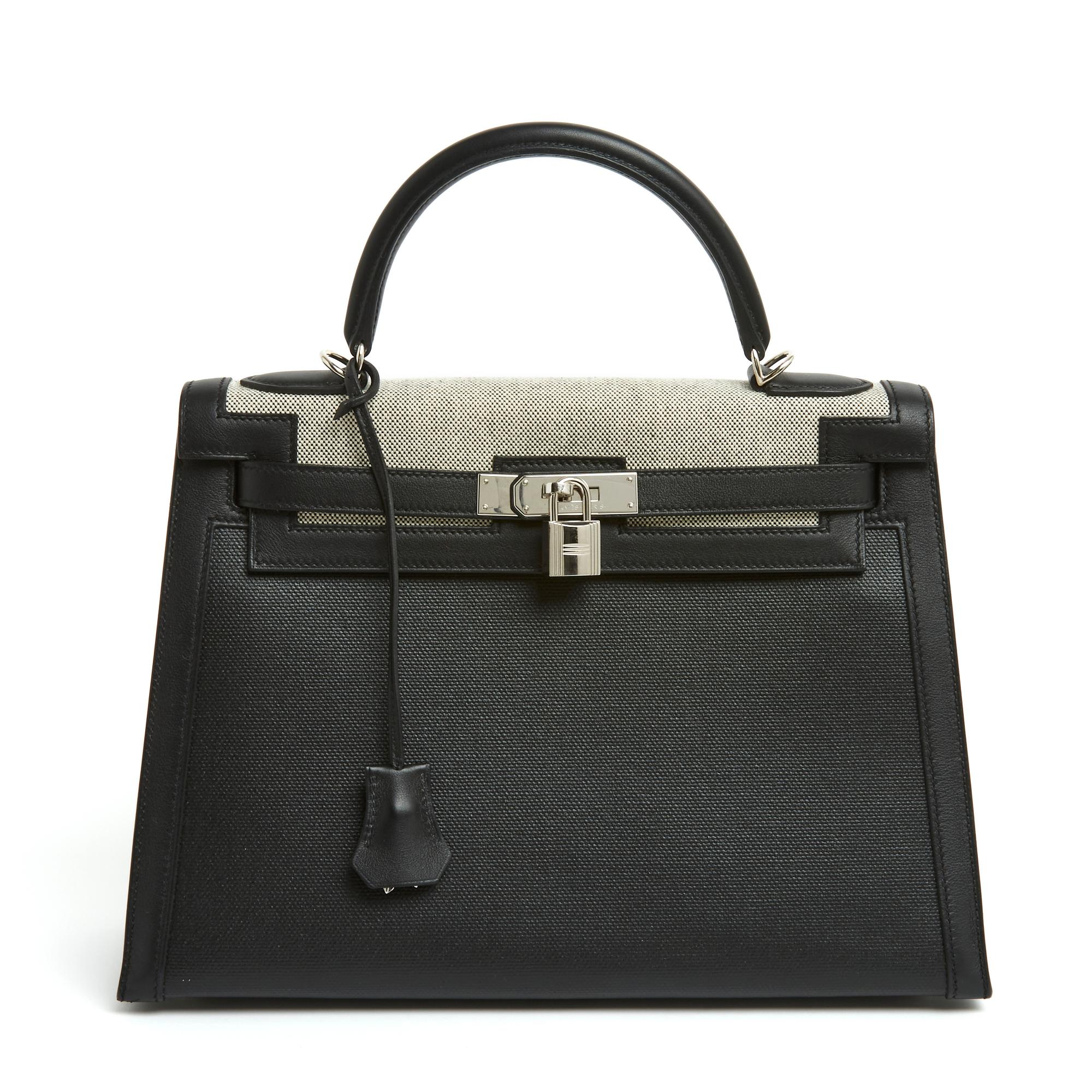 Hermès Kelly II Sellier model bag, size 32, in black grained leather and natural-colored Hermès canvas (on the flap) or black (body of the bag) and silver metal (palladium), interior in black leather with a pocket closed by a zip with puller leather