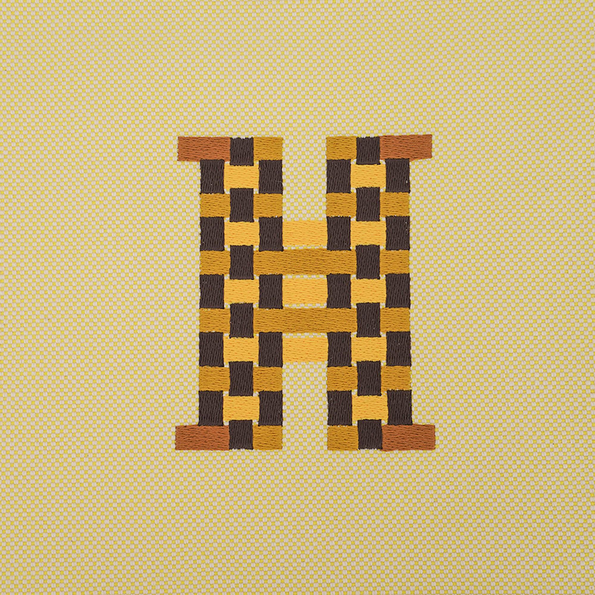 Mightychic offers an Hermes H Tissage canvas Bain case featured in Citron.
This large model flat case is embroidered with the 