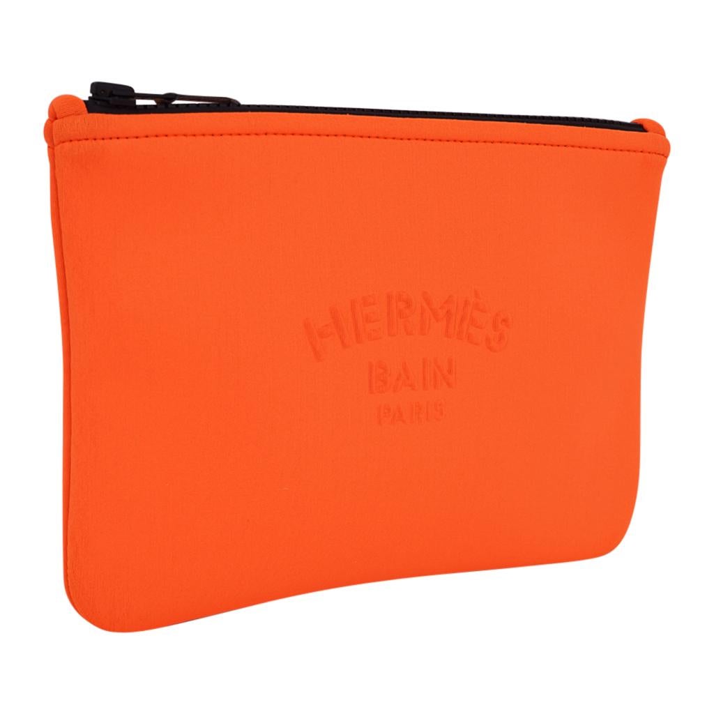 Mightychic offers an Hermes Neobain flat pouch case in coveted Orange.
Hermes Bain Paris embossed on front.
Top zipper with leather zipper toggle. 
Polyamide and elastane makes this a wonderful flat travel case, or perfect case on a yacht, or at the