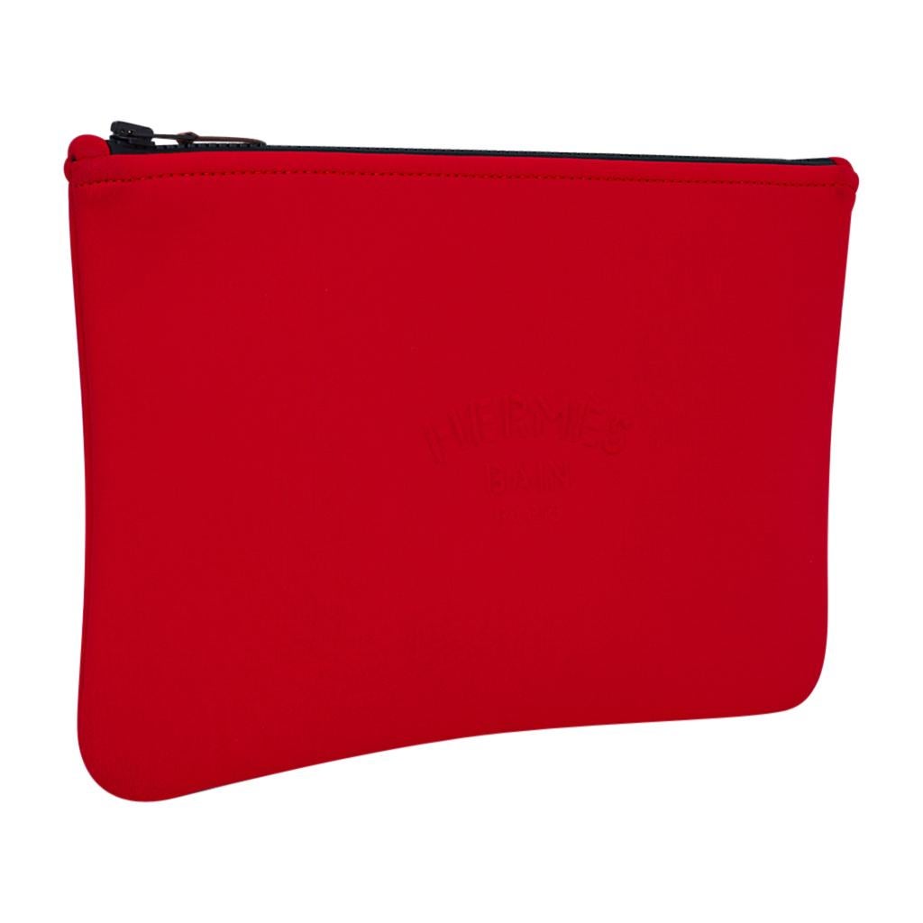 Mightychic offers an Hermes Bain Neobain case featured in the medium model.
Vivid Rouge Casaque  with Hermes Bain Pairs embossed on front.
Top zipper with leather zipper toggle.
Polyamide and elastane makes this a wonderful flat travel case, or
