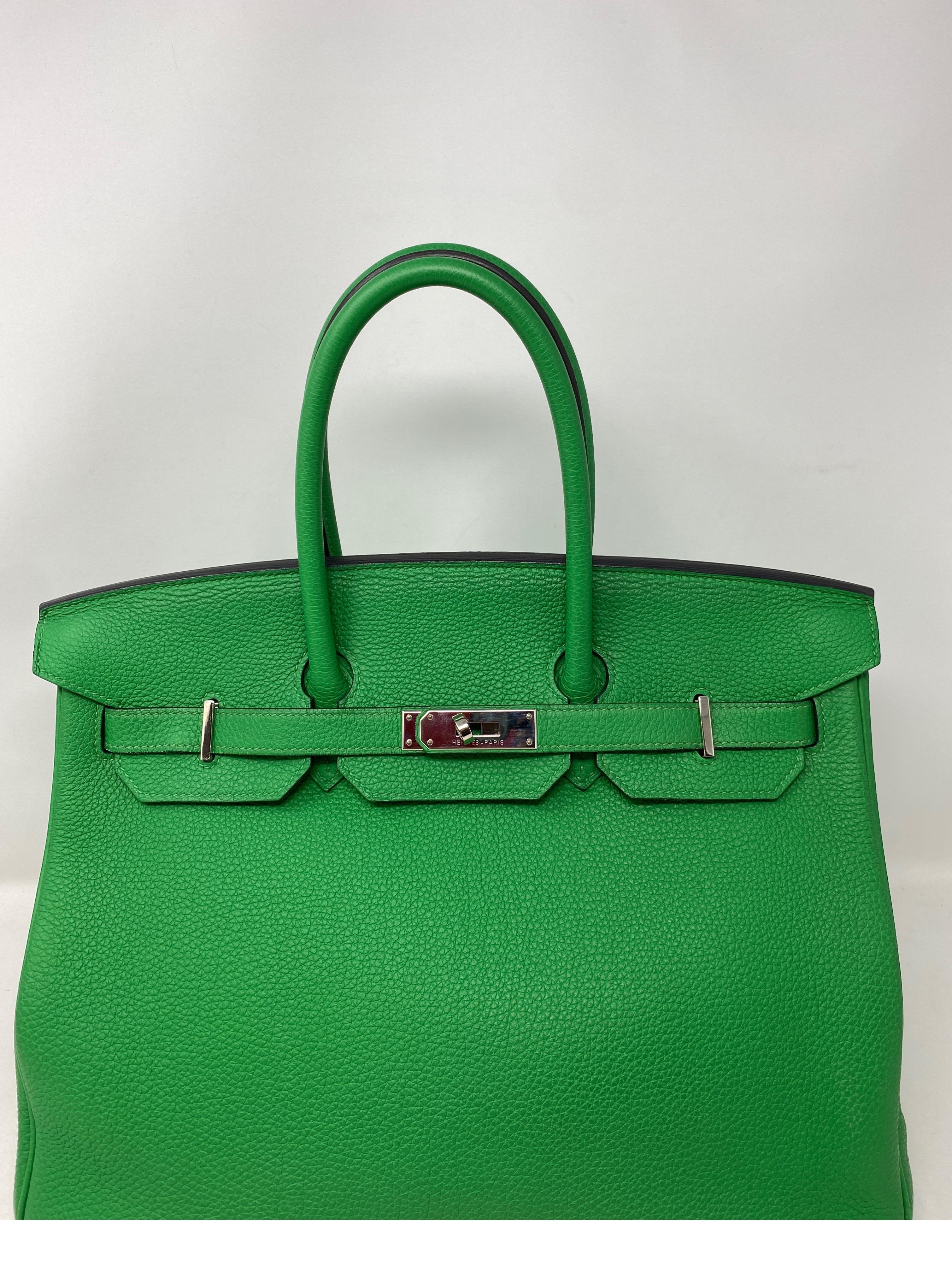 Bolso Birkin 35 verde bambú de Hermes. Herrajes de paladio. Bonito color verde vibrante. Plástico todavía en el hardware. Excelente estado como nuevo. Sello P de 2012. Color raro. Incluye clochette, candado, llaves y funda guardapolvo. Autenticidad
