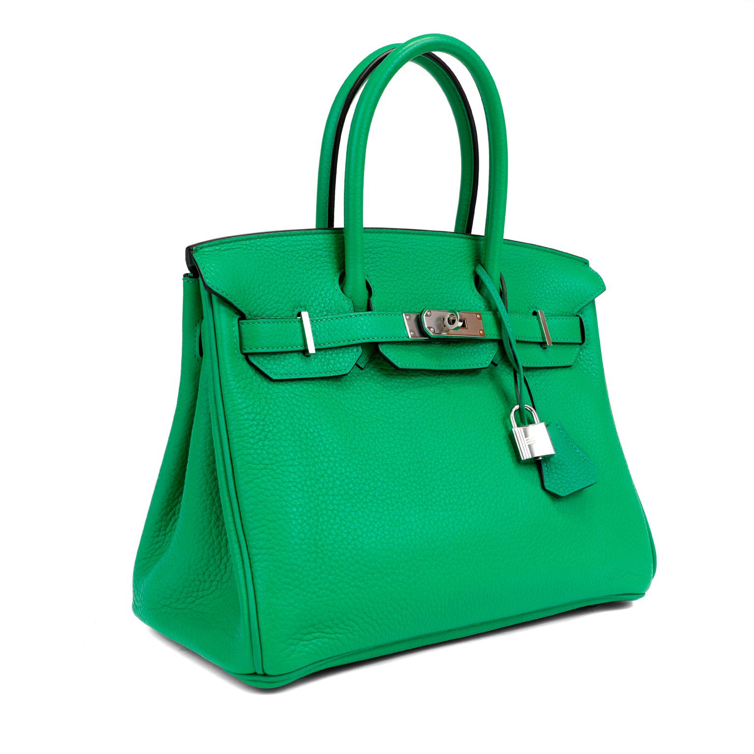 This authentic Hermès Bamboo Green Togo 30 cm Birkin is in pristine condition with the protective plastic on the hardware.   Hand stitched by skilled craftsmen, wait lists of a year or more are common for the Hermès Birkin. They are considered the