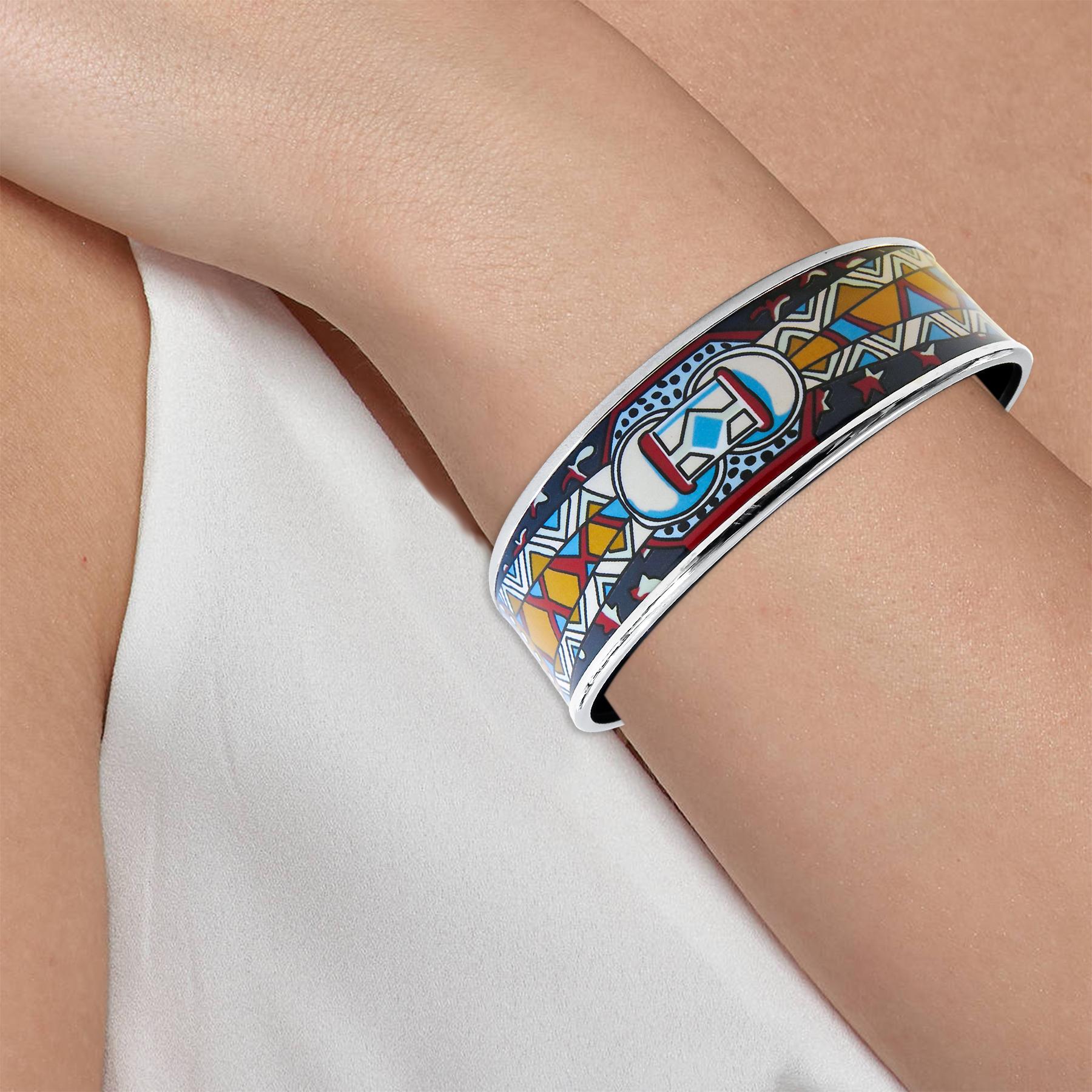 This Hermes bangle features a platinum-plated with a printed pattern enamel. Carved in Austria, It weighs 36.8 grams, 20mm wide and has an inner diameter of 2.8 inches to give a comfortable fit in your wrist. 
Condition: Excellent 
