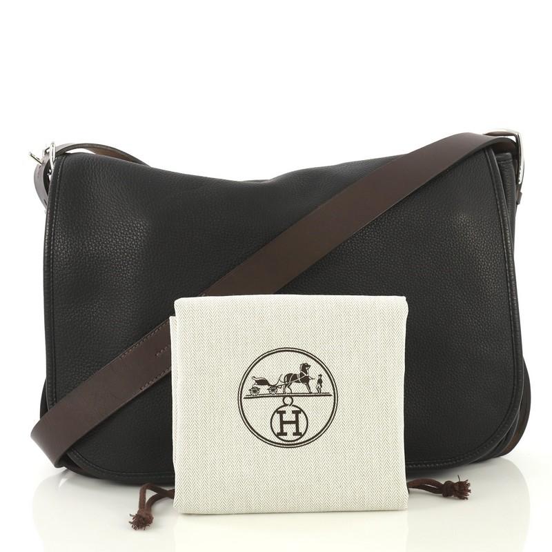 This Hermes Barda Messenger Bag Clemence 35, crafted from Noir black Veau Alamo and Ebene brown Vache Hunter leather, features an adjustable crossbody strap, full frontal flap, and palladium hardware. It opens to a Noir black Veau Alamo leather