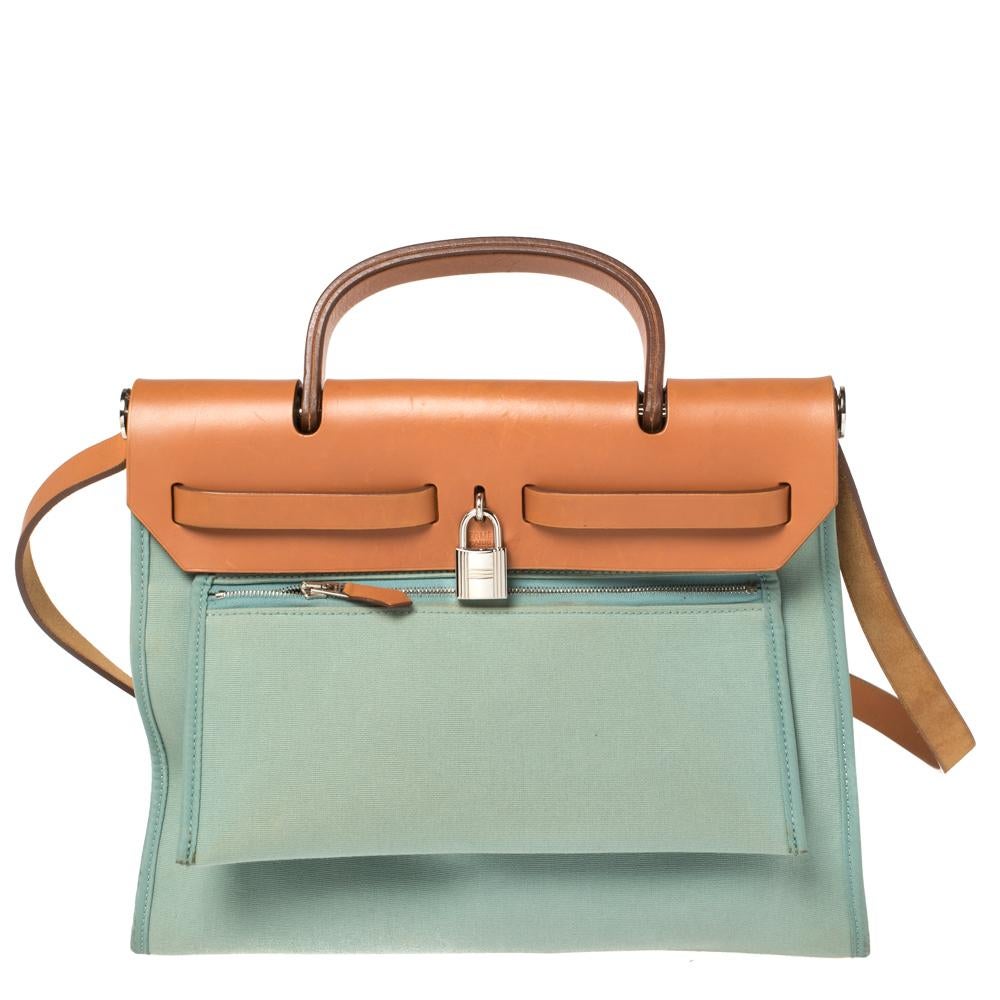 Made from canvas and leather, the Herbag Zip is just as outstanding as all of Hermes' other handbags. First introduced in 2009 as a new version of the Herbag, this piece comes with a single handle, a long shoulder strap and it flaunts fabulous