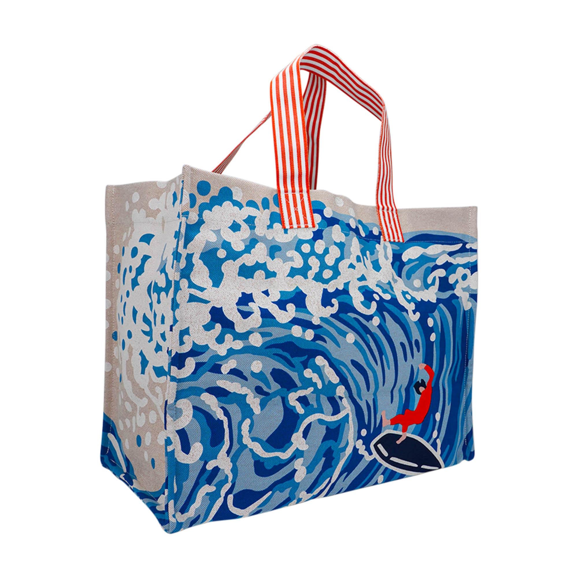 Mightychic offers an Hermes Wave Beach bag featured in Denim.
Depicts a surfer riding a big wave.
Two orange interior pockets.
Can be carried over the shoulder or by hand.
Woven and screen printed in France.
Marvelous spacious tote!
Hermes Beach