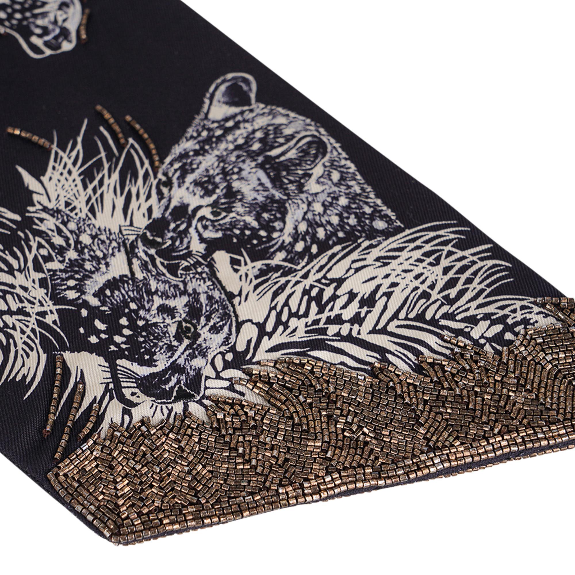 Mightychic offers a Hermes embellished Guepards Maxi-Twilly Slim featured in Black and White.
Beautiful bronze metallic beading at tips.
Beading throughout accentuating the running leopards.
Designed by Robert Dallet.
Comes with signature Hermes box