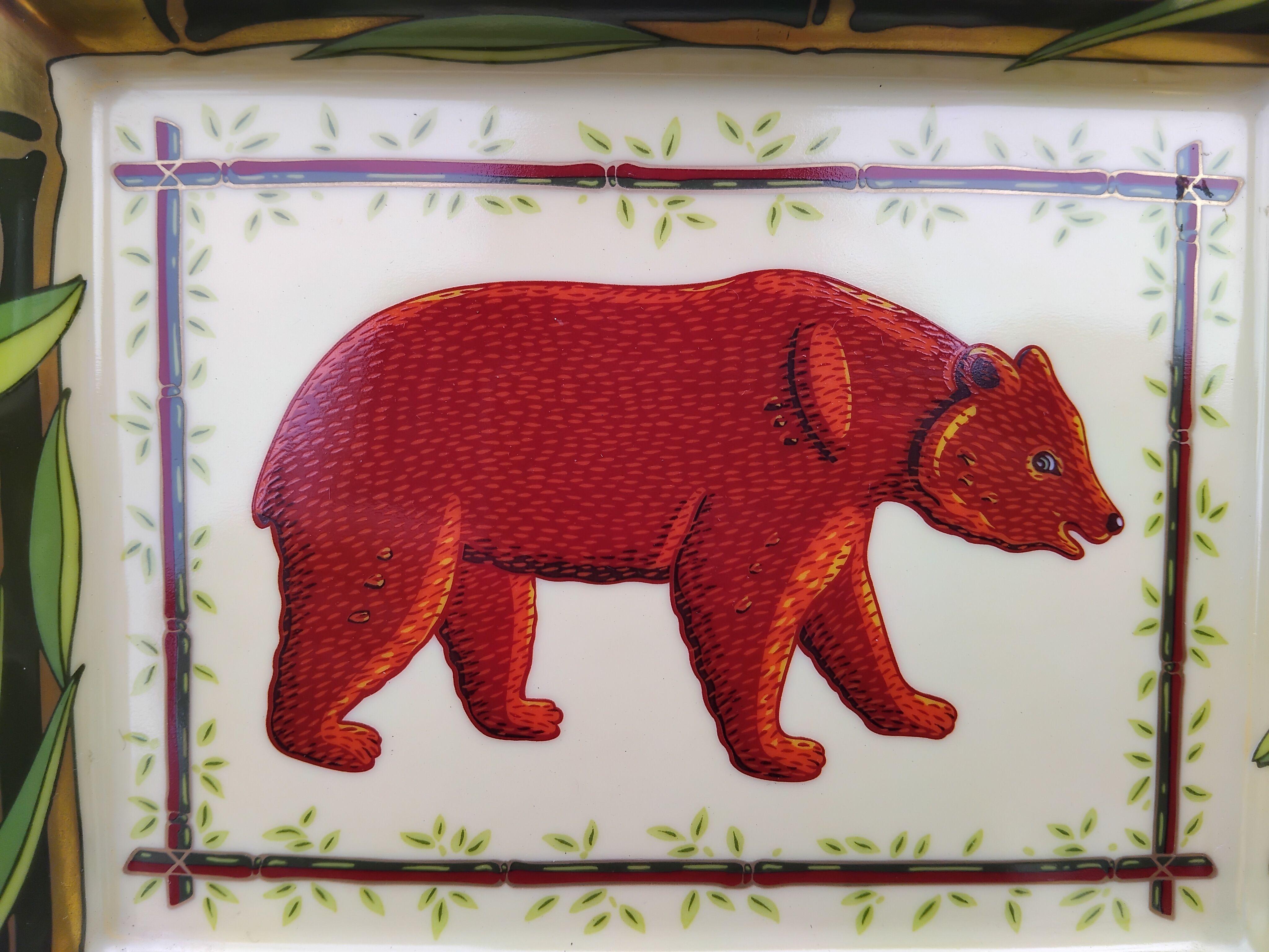 Beautiful Authentic Hermès Ashtray

Bear: Bear in a bamboo decor

Made in France

Made of printed porcelain, edges and notches hand painted with fine gold

Bottom covered with burgundy suede leather

Colorways: pale yellow, brown, green, burgundy,
