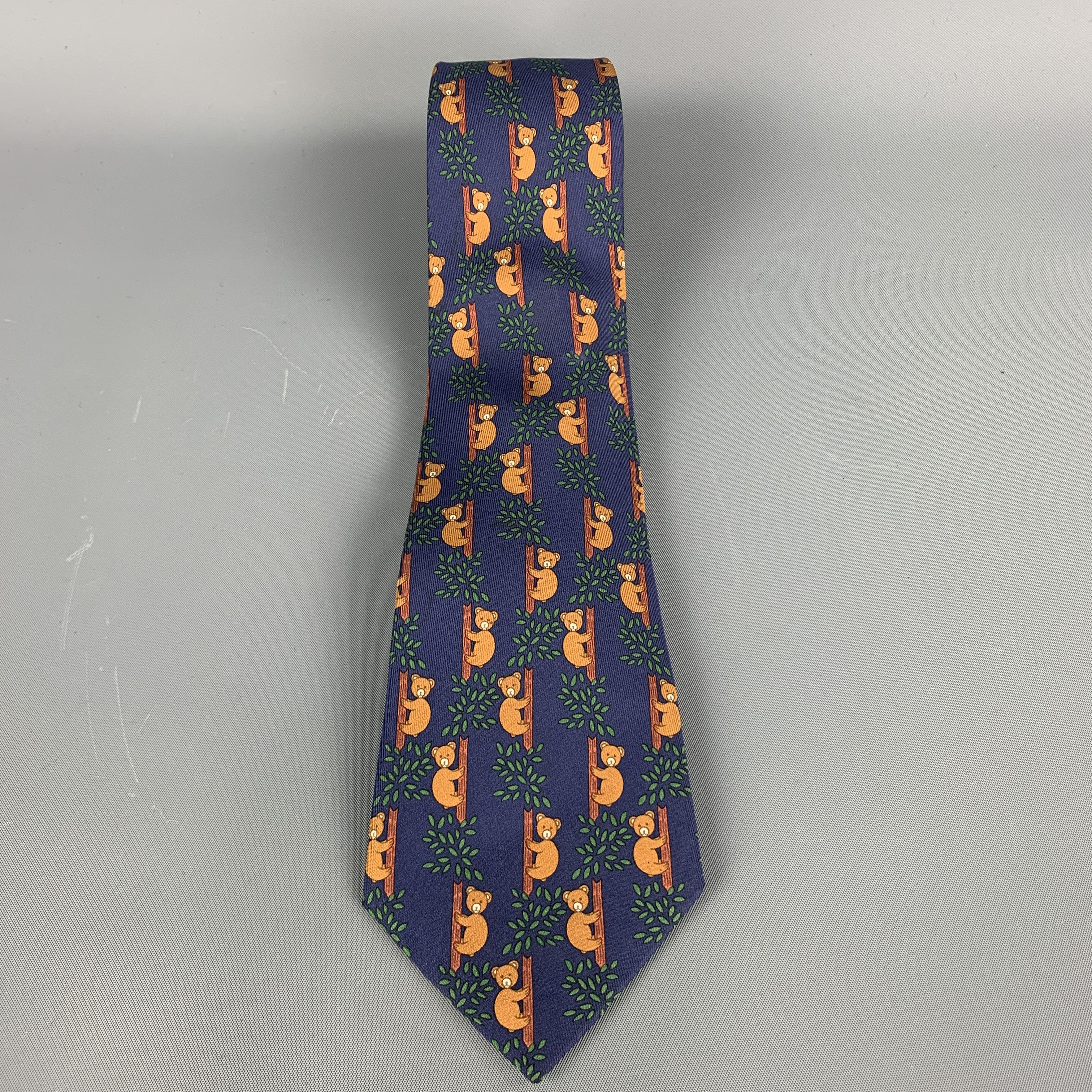 Vintage Hermes skinny necktie comes in navy and brown silk twill with all over 