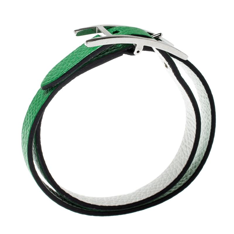 Made in green and white leather, this Double Tour bracelet is a loved design from the house of Hermes. This bracelet features an H-shaped palladium-plated buckle and it can be worn on both sides in any of the two colours.

Includes: Original