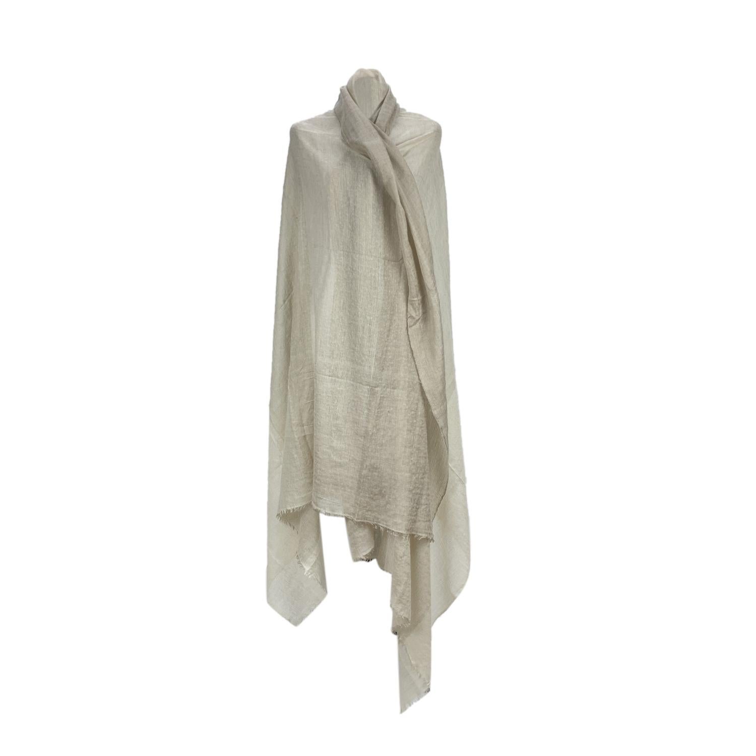 Rare cashmere and silk scarf by Hermes. Beige color. Composition; 50% Cashmere, 50% Silk. Fringed hem. Approx. measurements: 50 x 90 inches - 127 x 229. Handwoven in Nepal. 'HERMES - Paris' and composition tags are still