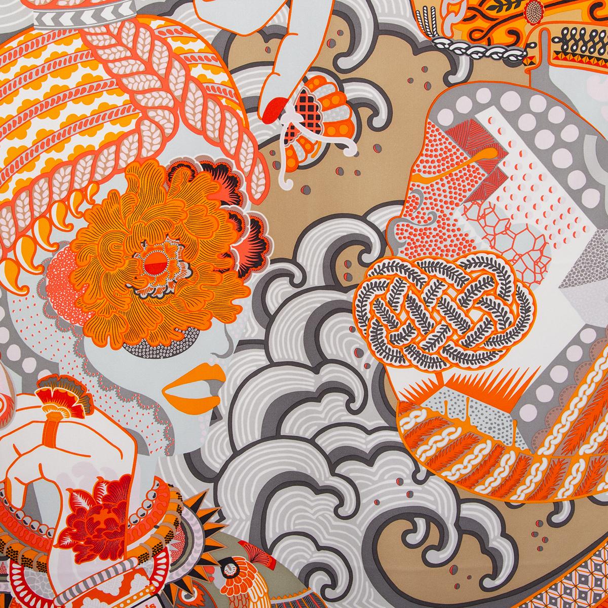 100% authentic Hermès 'Duo Cosmique 90' scarf by Kohei Kyomori in orange silk twill (100%) with a caramel border and details in grey, white, yellow and red. Brand new. 

Issued in Fall/Winter 2021.

In Tantric Buddhism, 